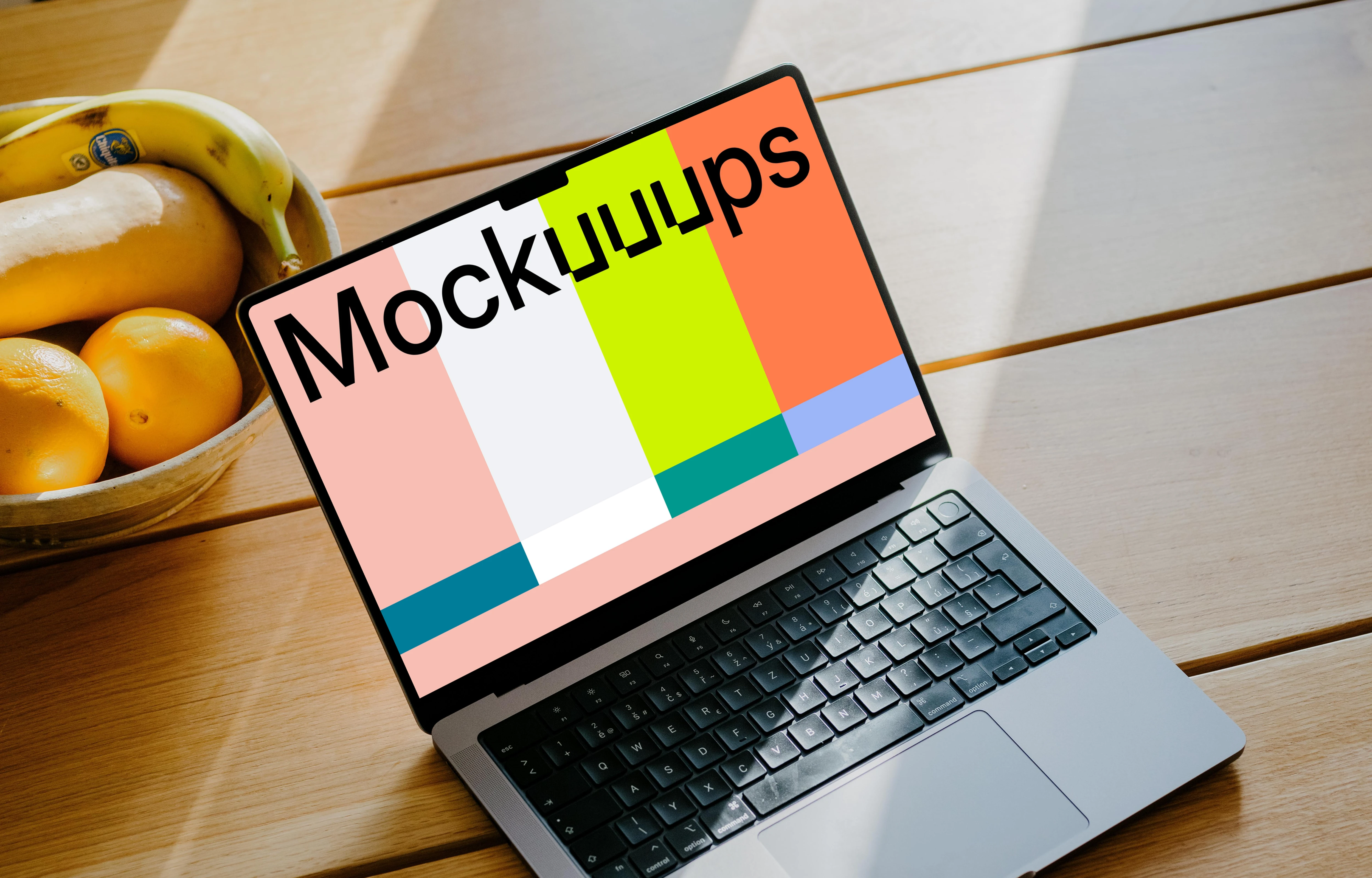 MacBook Pro mockup on a table in front of a basket of fruits