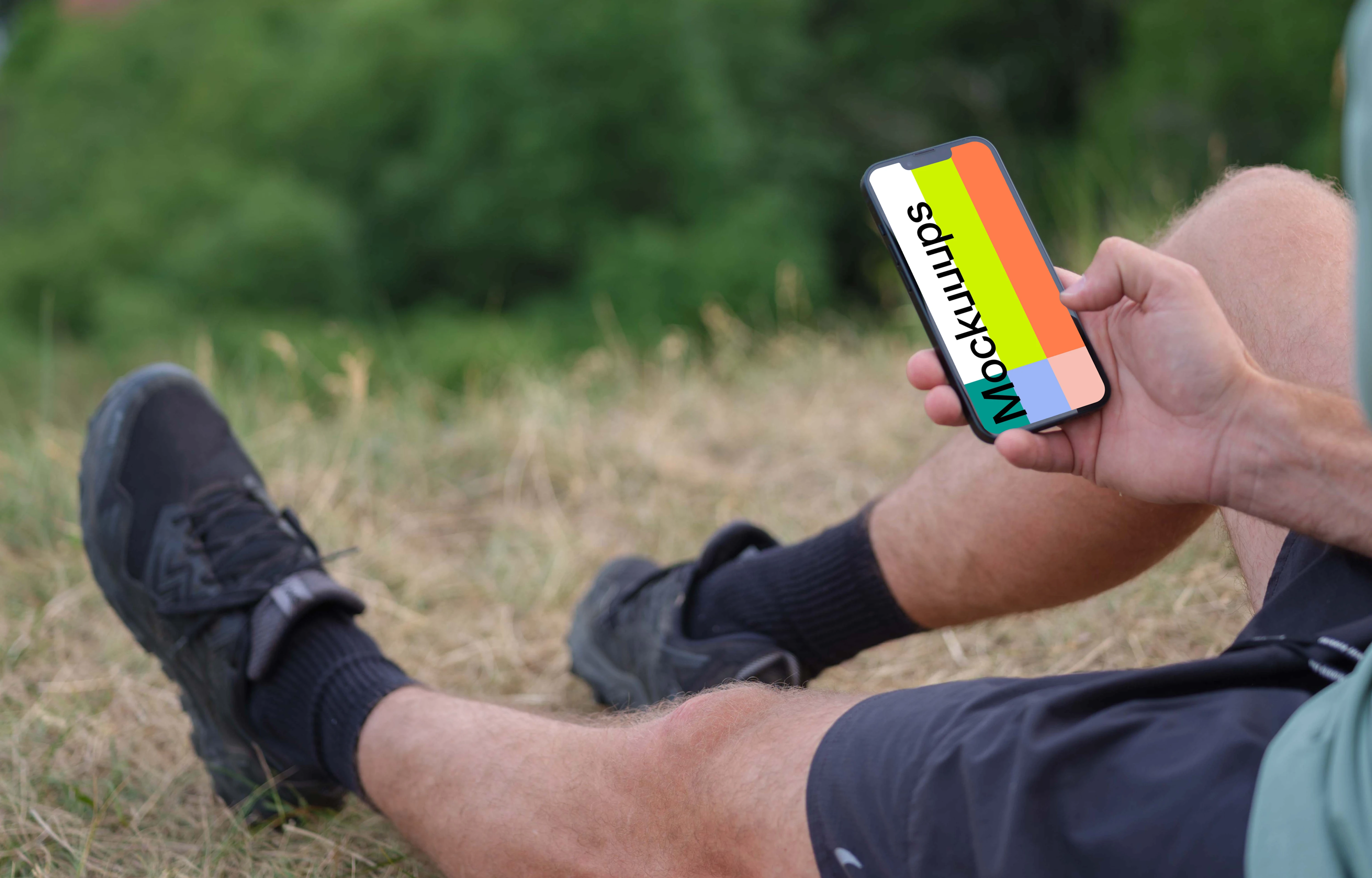 Male hand typing on an iPhone mockup