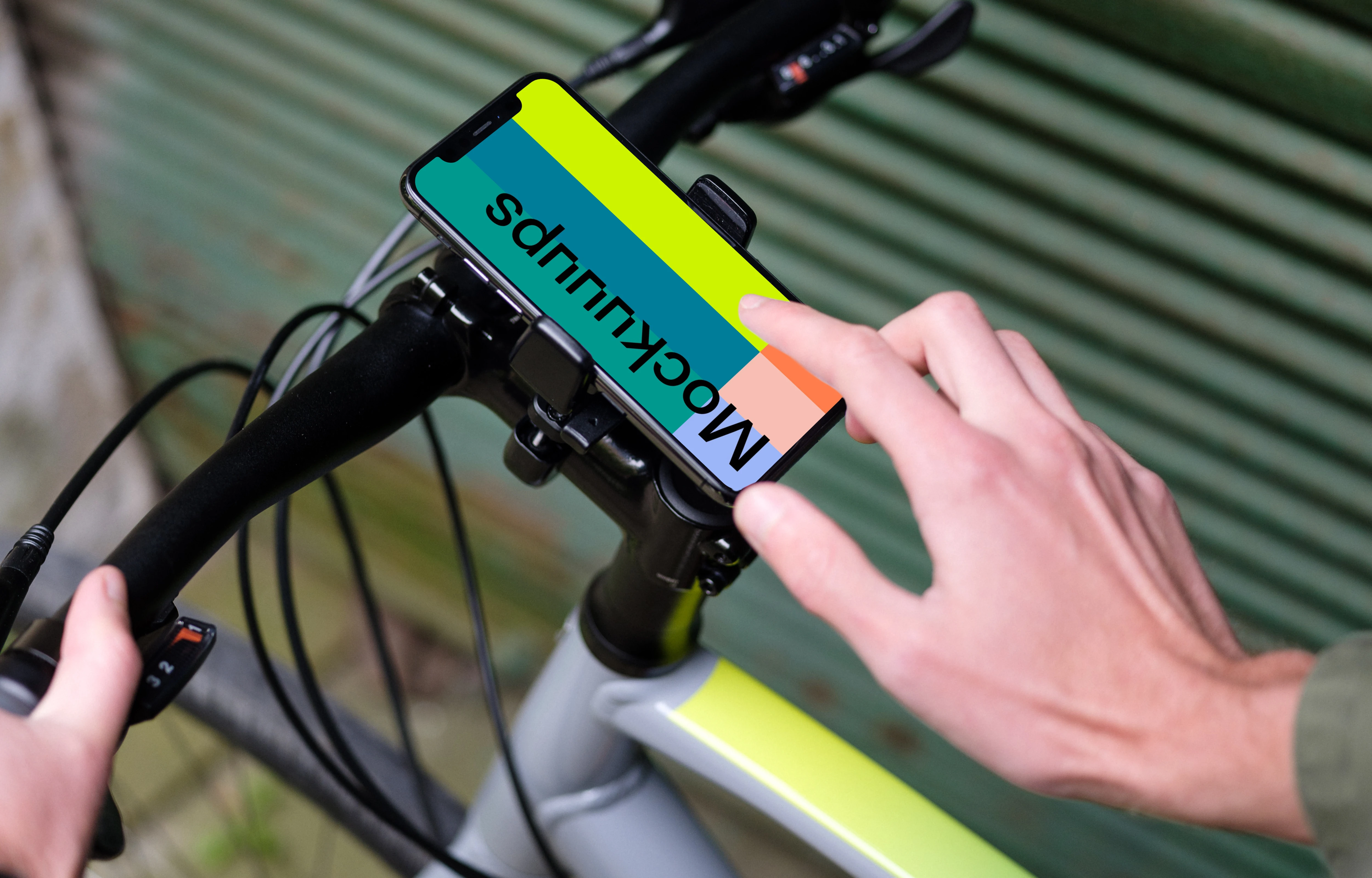 Man on bike next to a garage with iPhone 11 Pro mockup in bike mount