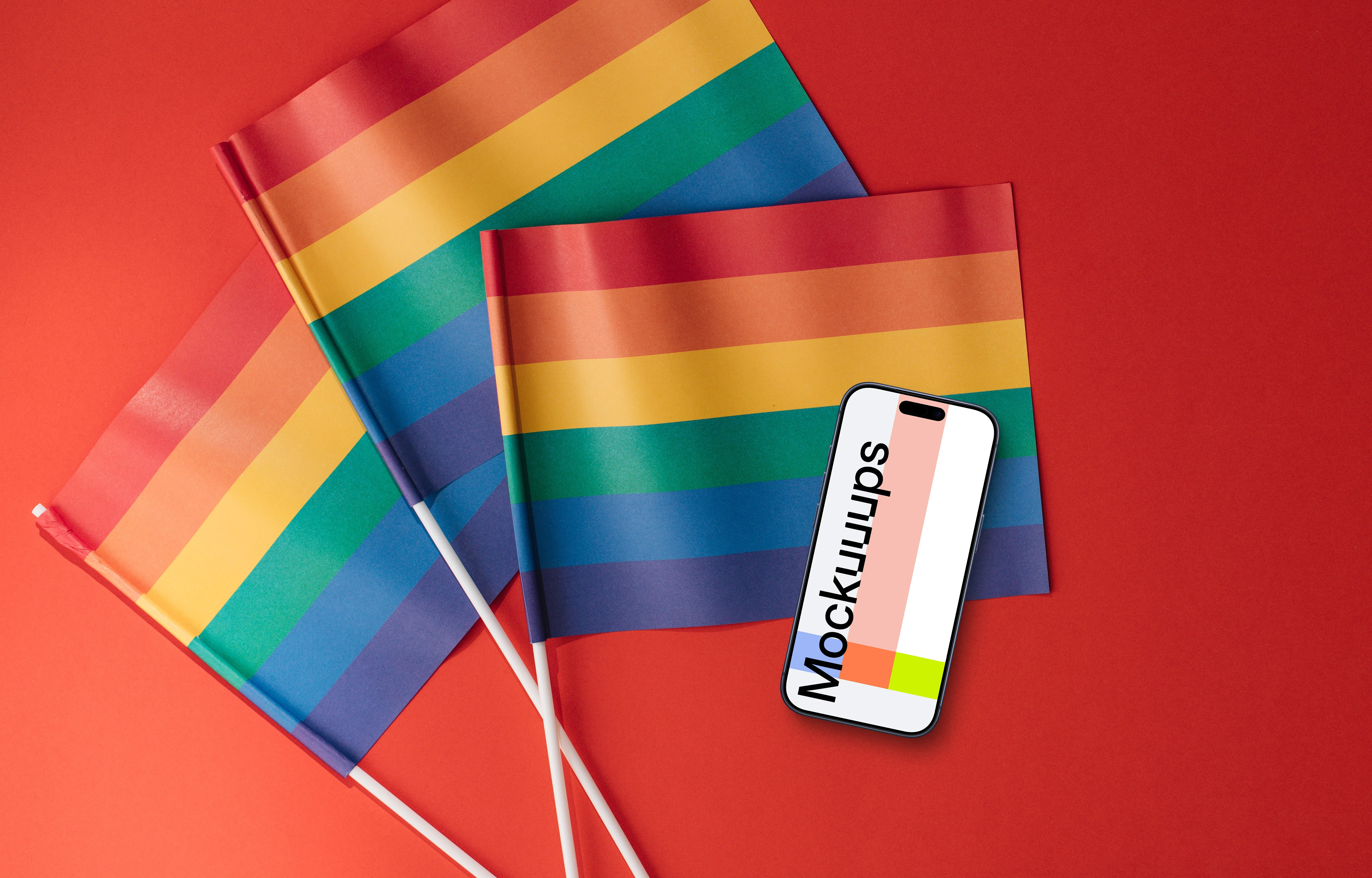 Smartphone mockup atop three rainbow flags