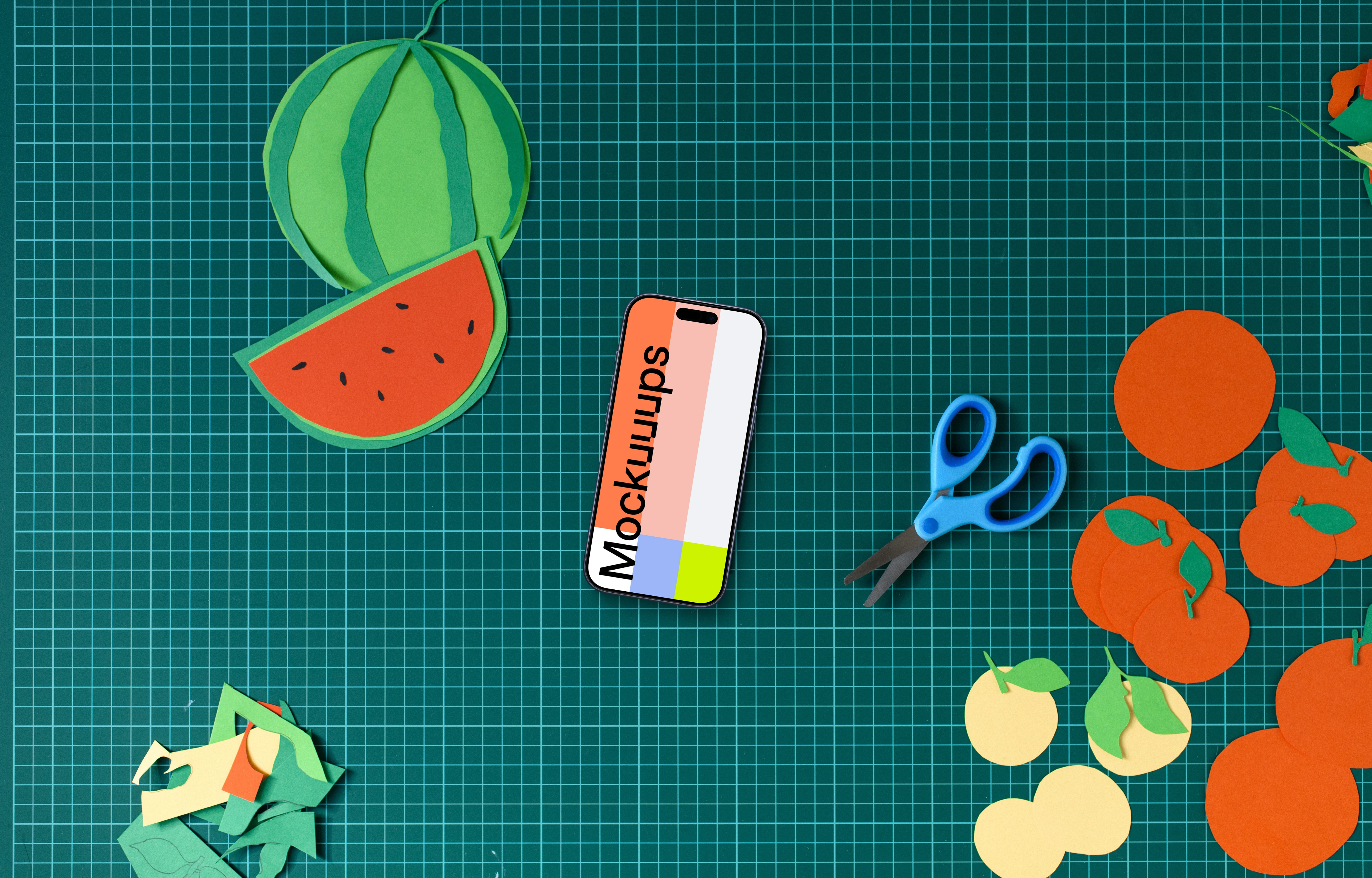 Smartphone mockup on crafting mat with colorful paper cutouts