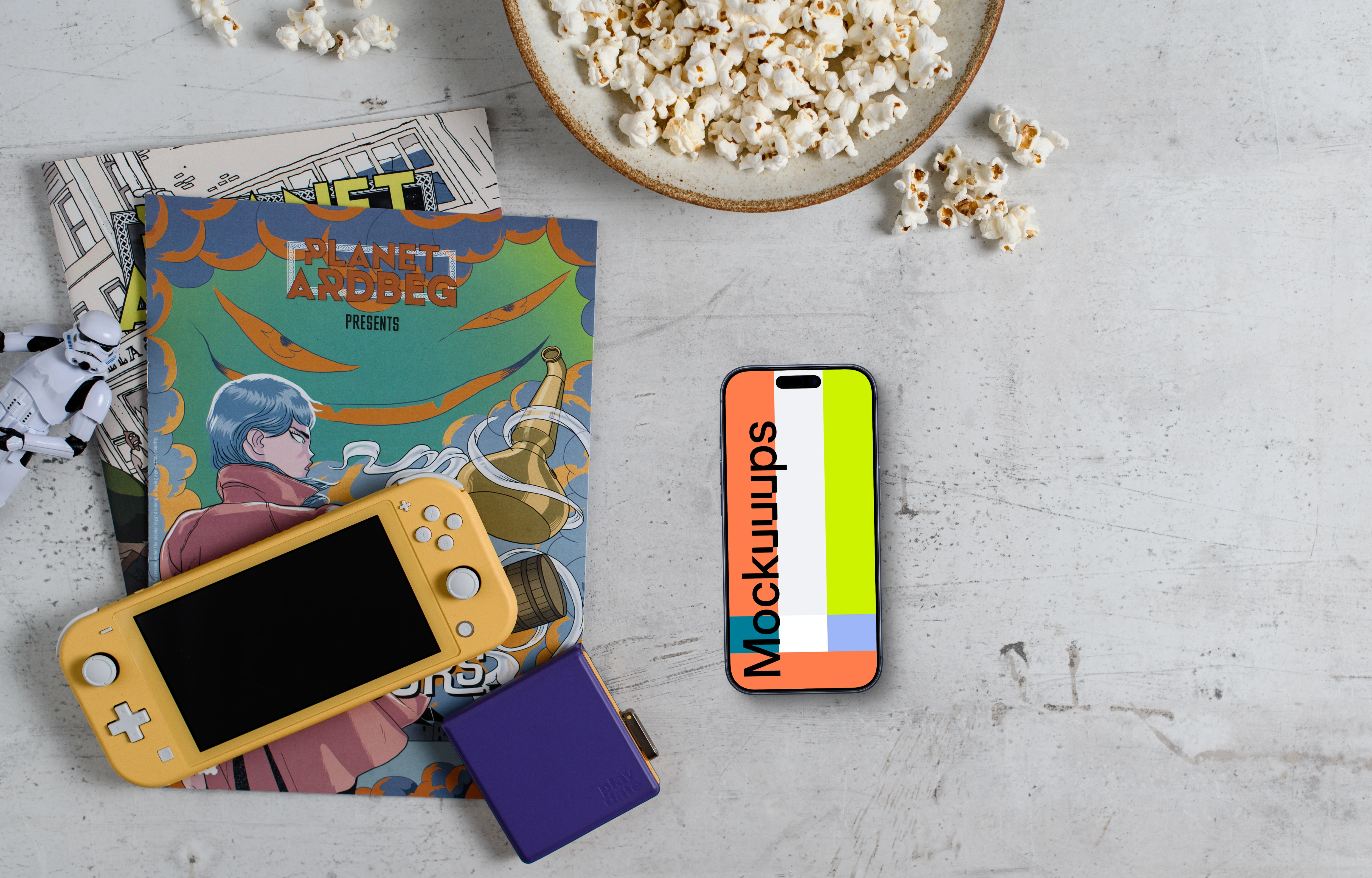 Smartphone mockup with gaming handheld and snacks