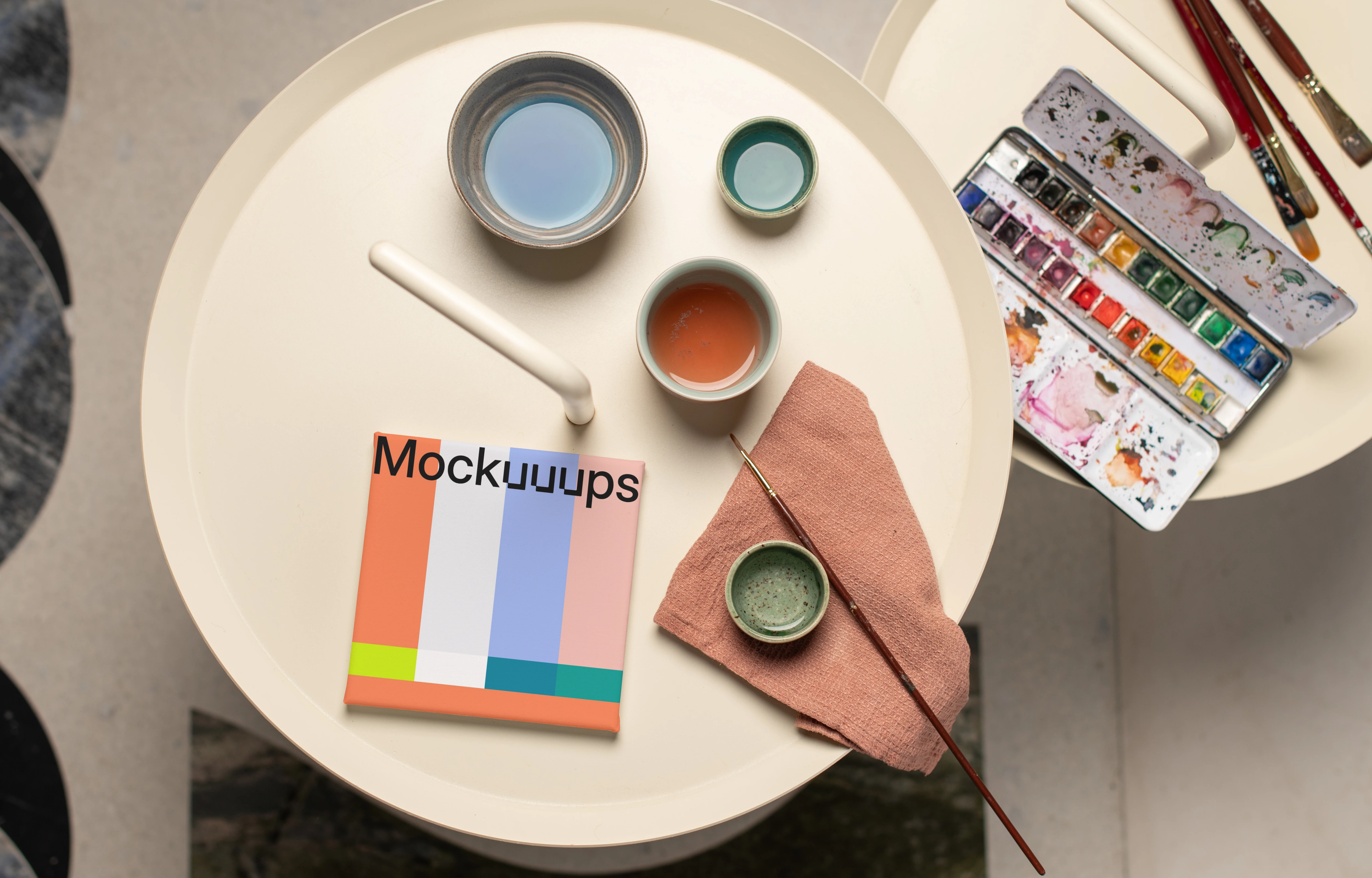 Square poster mockup with colorful palette and brushes