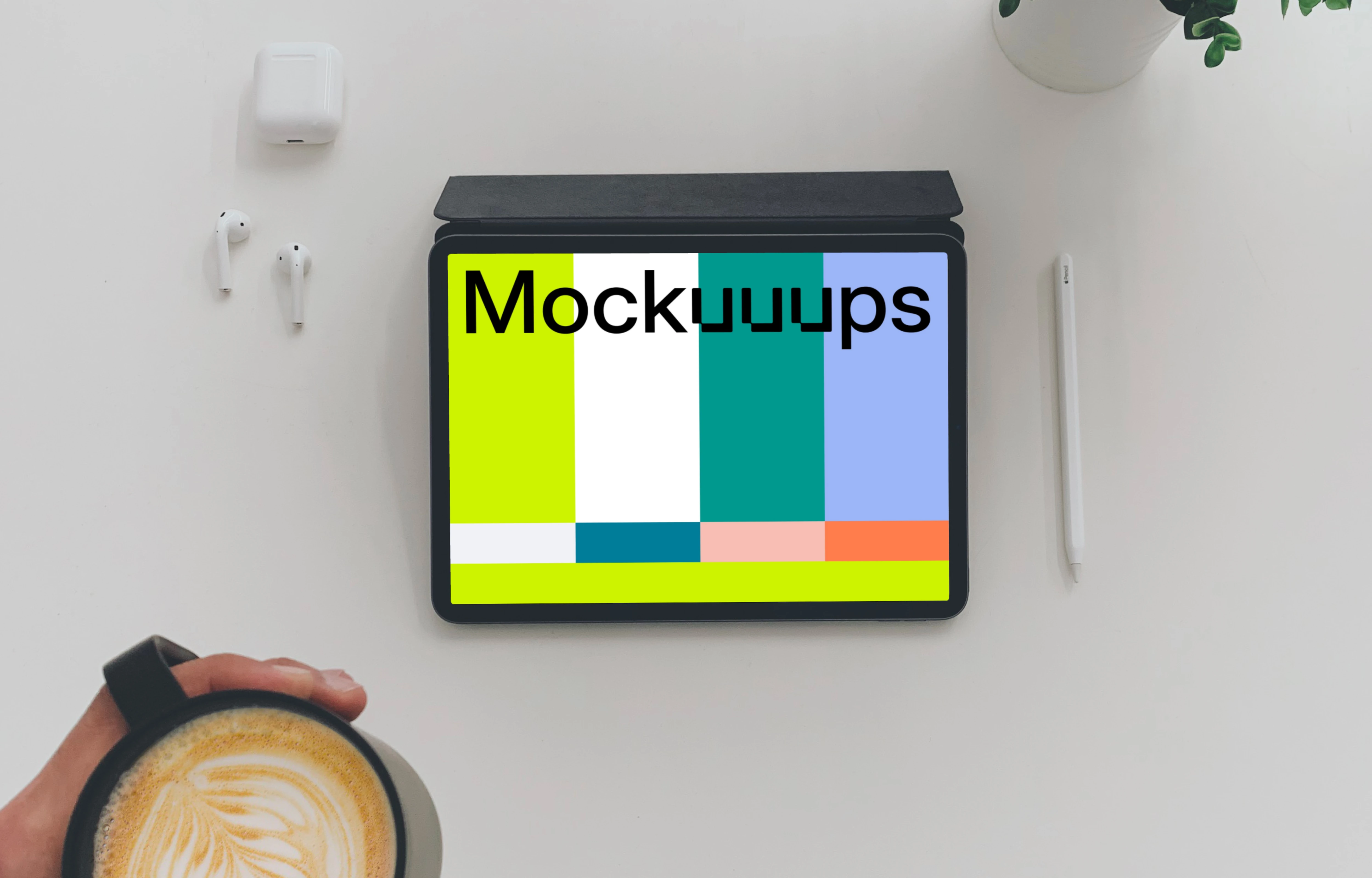 Tablet mockup on a white table with Airpods at the side