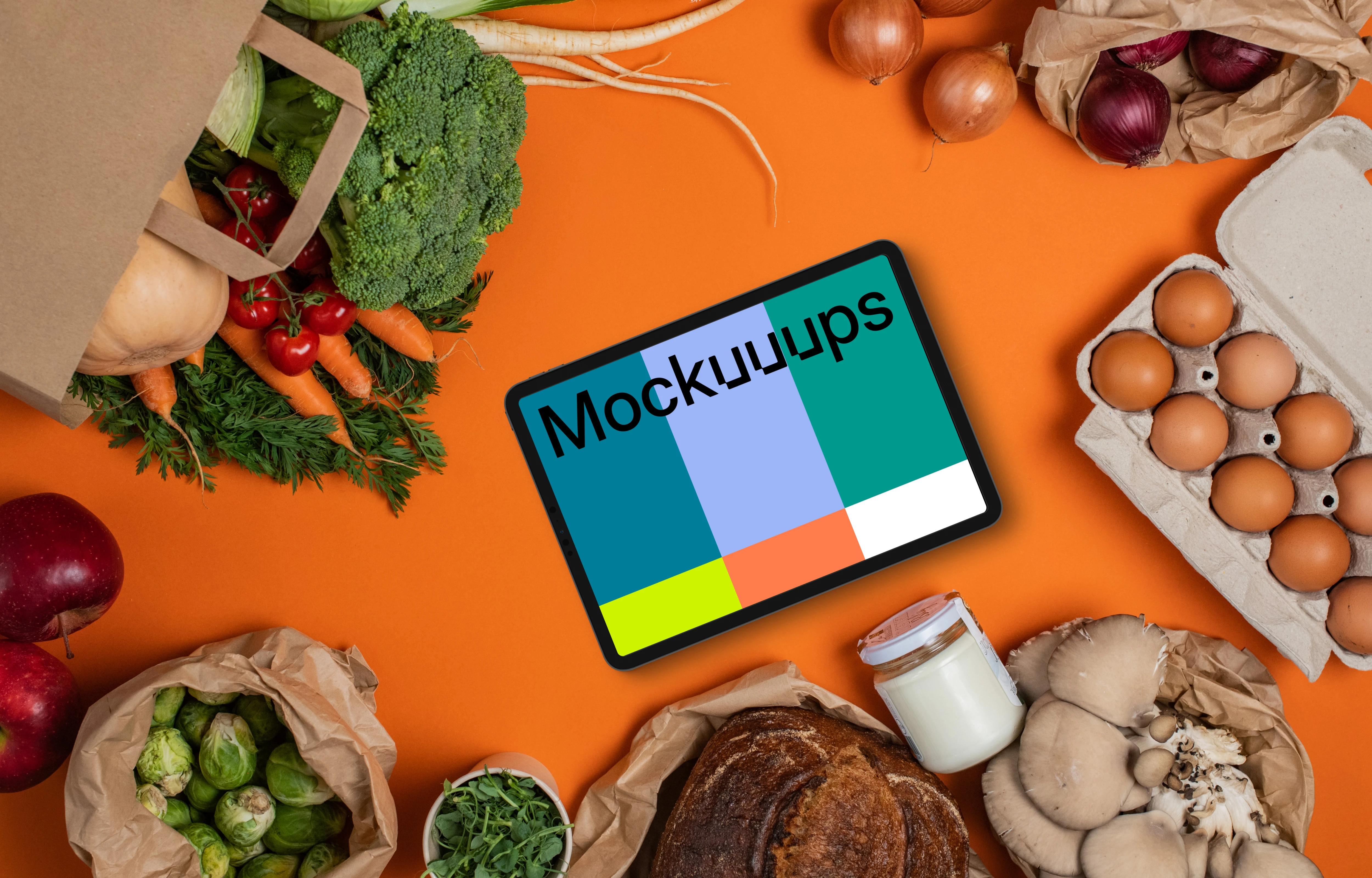 Tablet mockup surrounded by fresh groceries