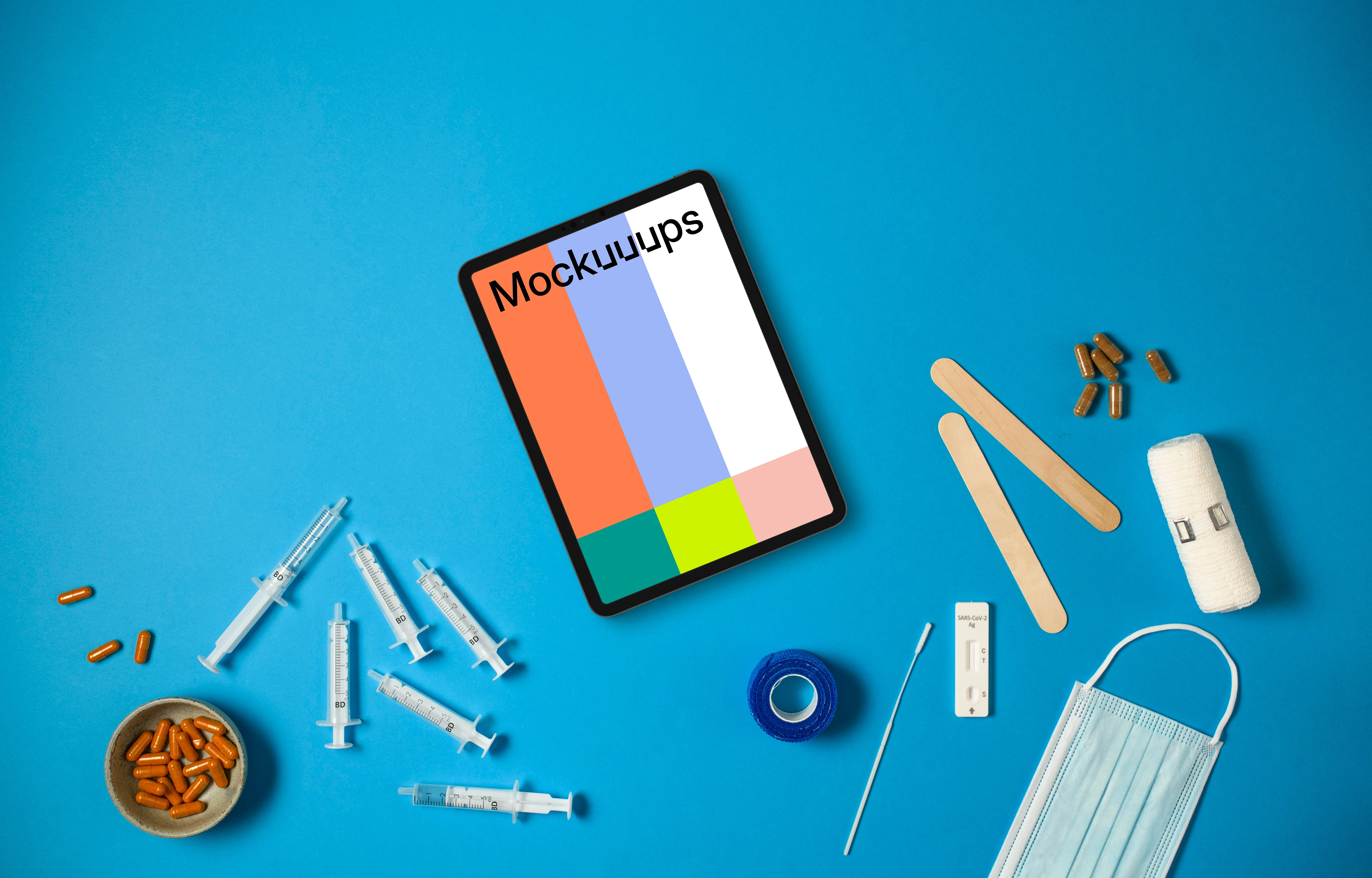 Tablet surrounded by medical essentials