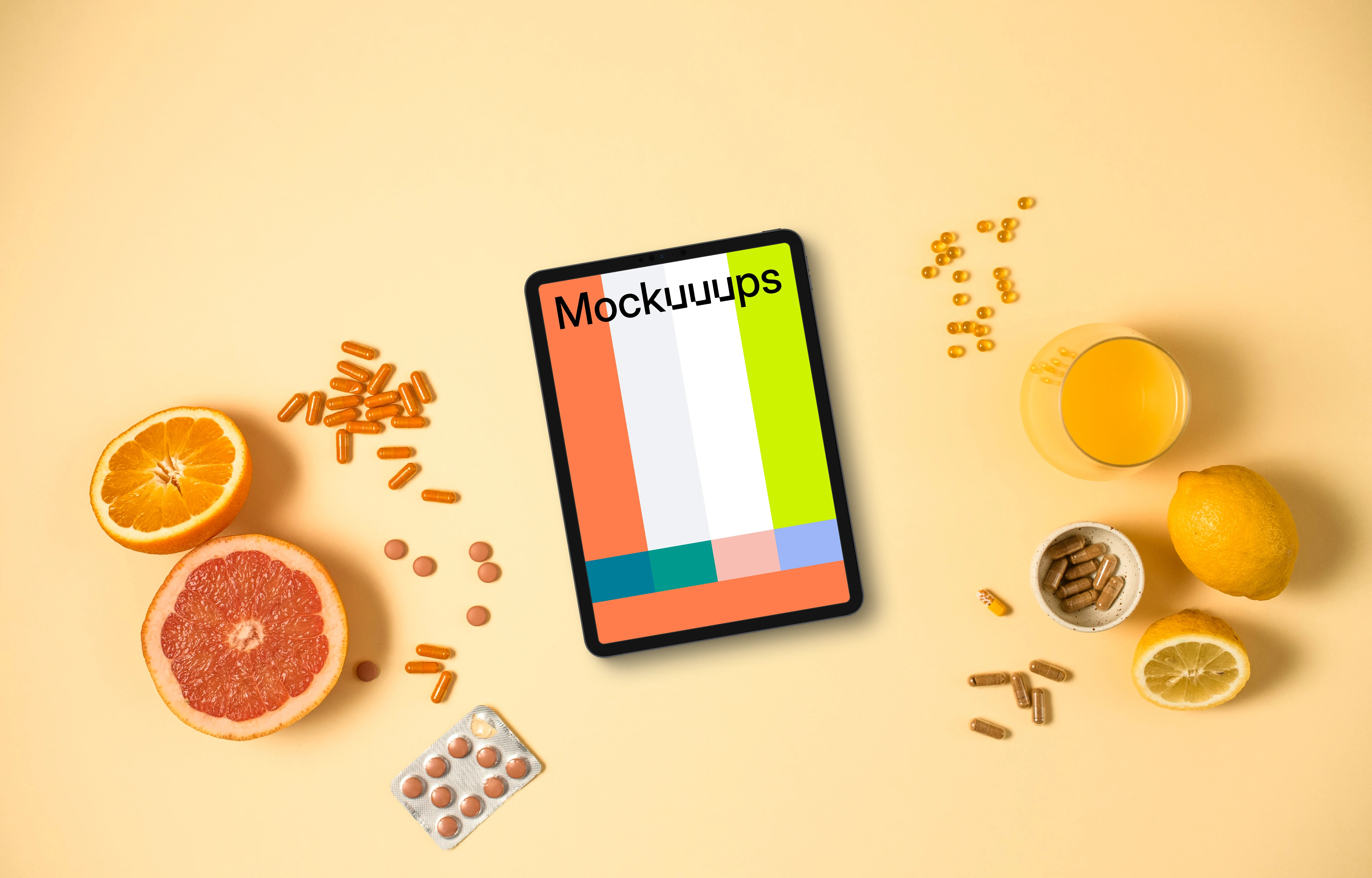 Tablet surrounded by pills and citrus fruits