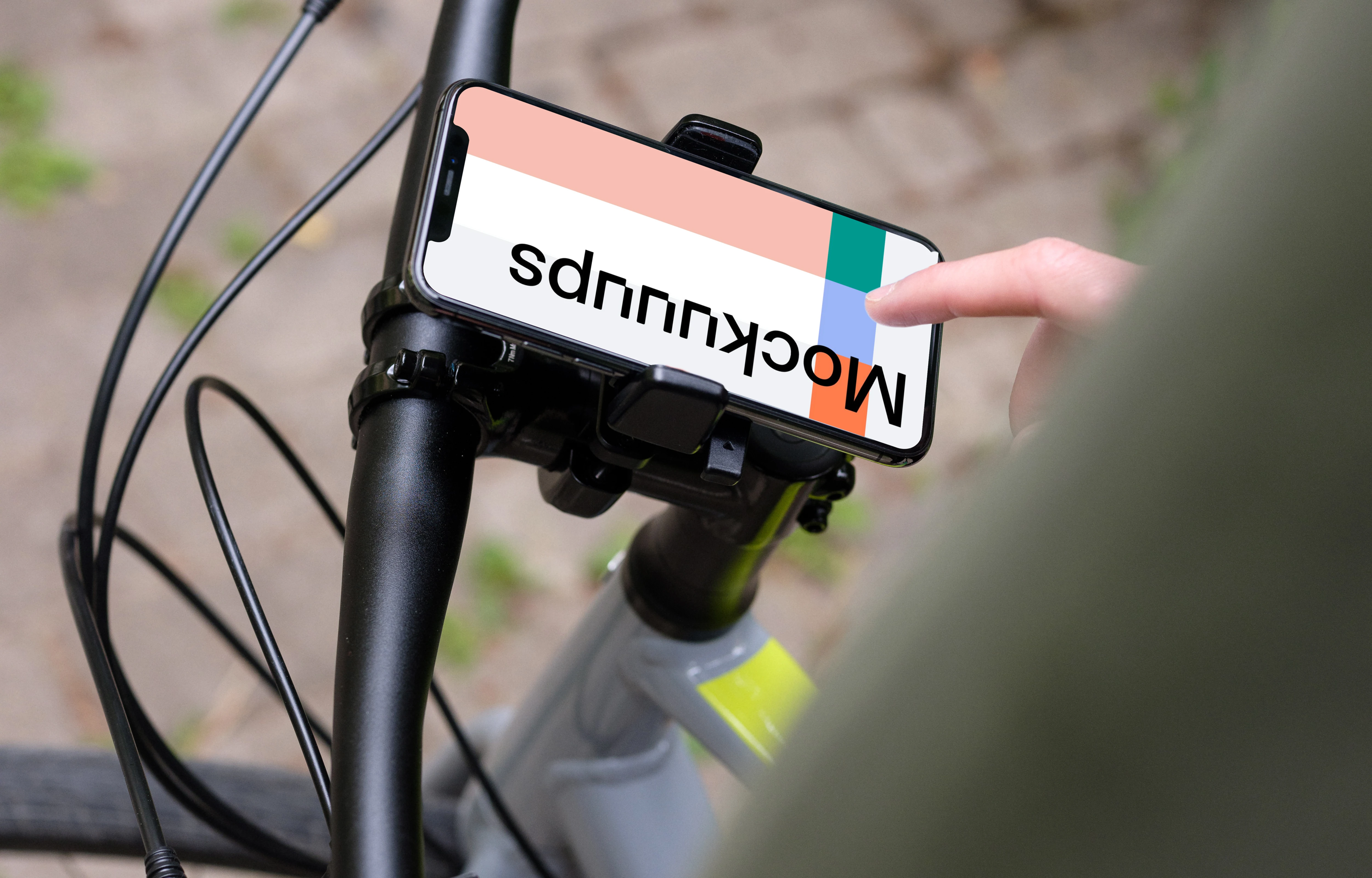 Tapping on iPhone 11 Pro mockup in bike mount with handlebars to the side