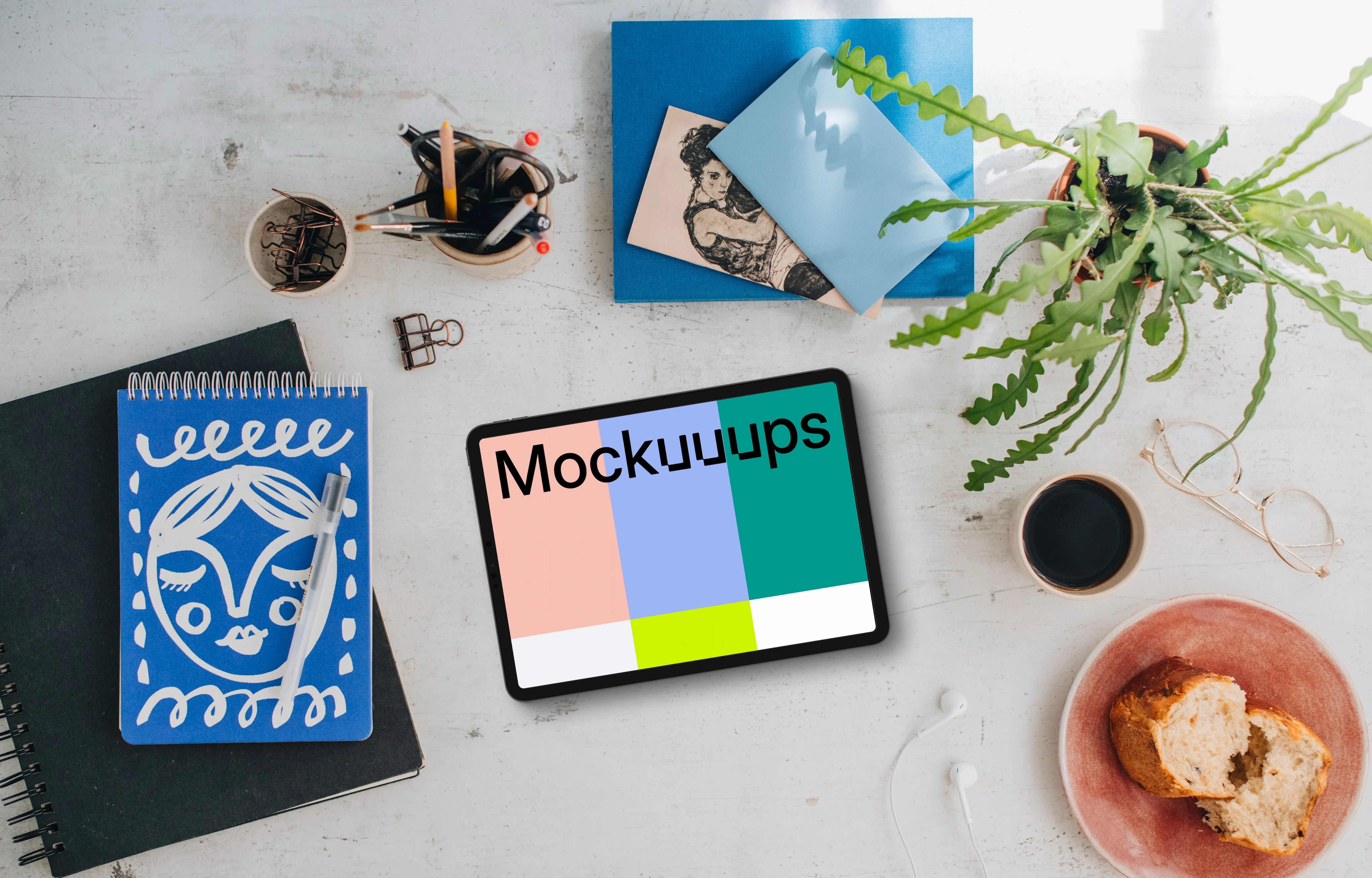 Mockup of tablet device with a plant and coffee on the side