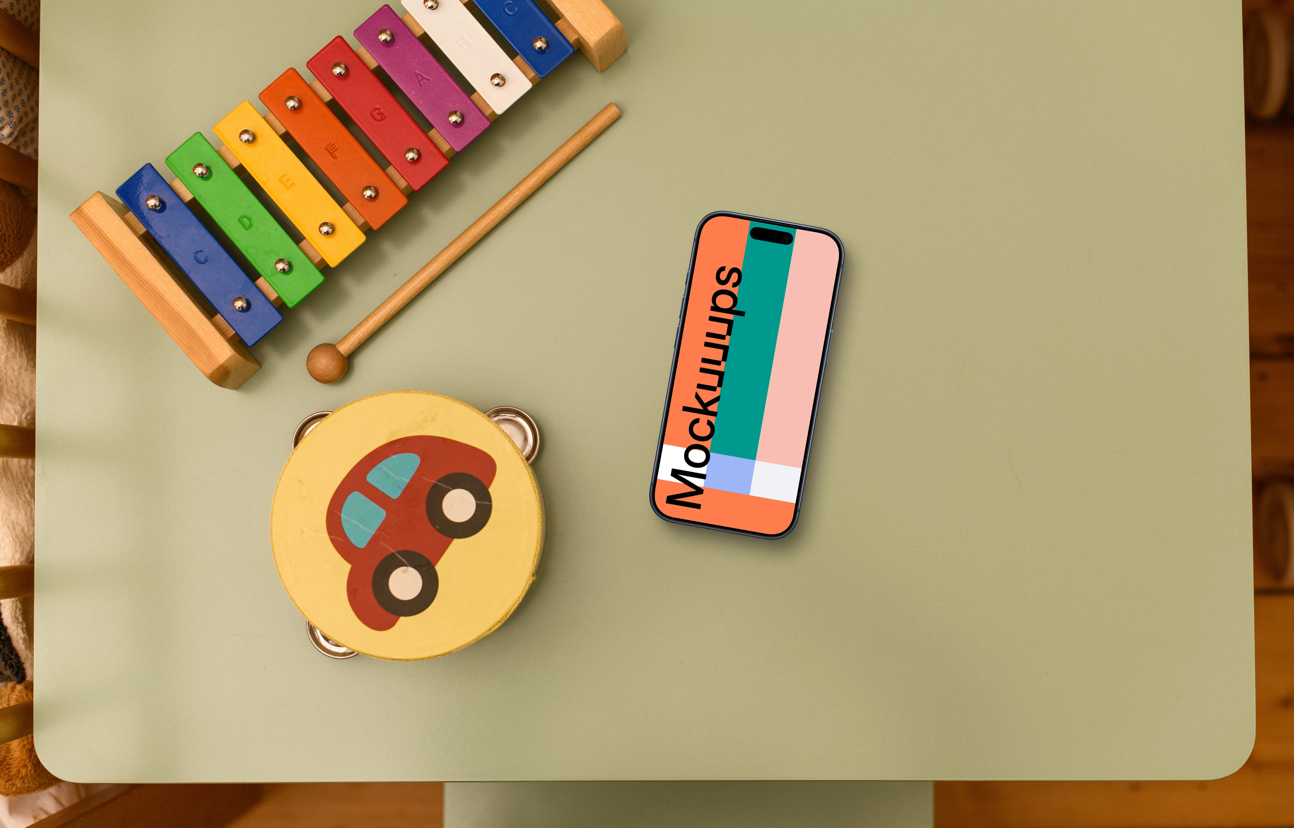 Smartphone mockup with children's toys on table