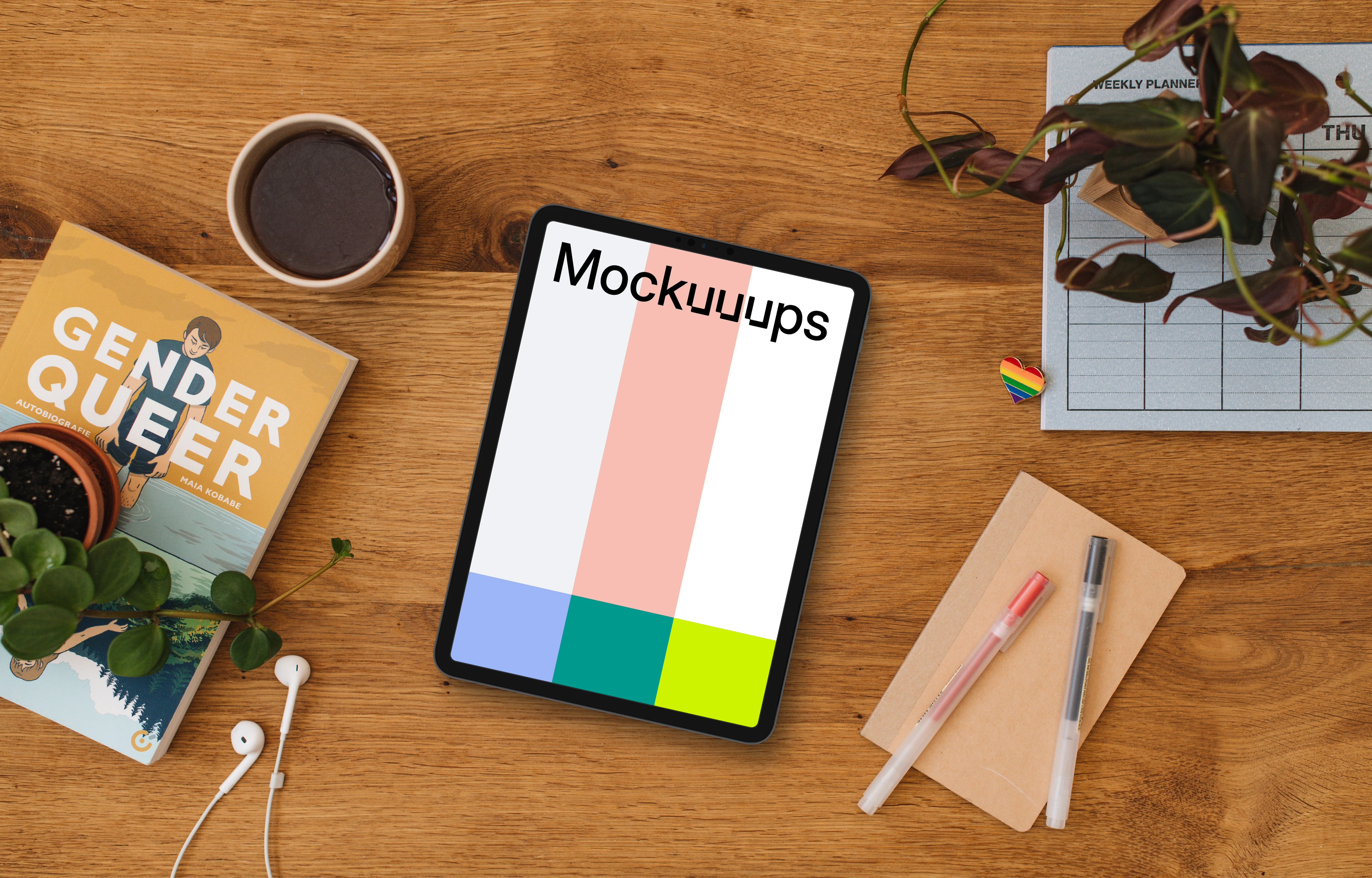 Wooden table with a tablet mockup and a pride pin