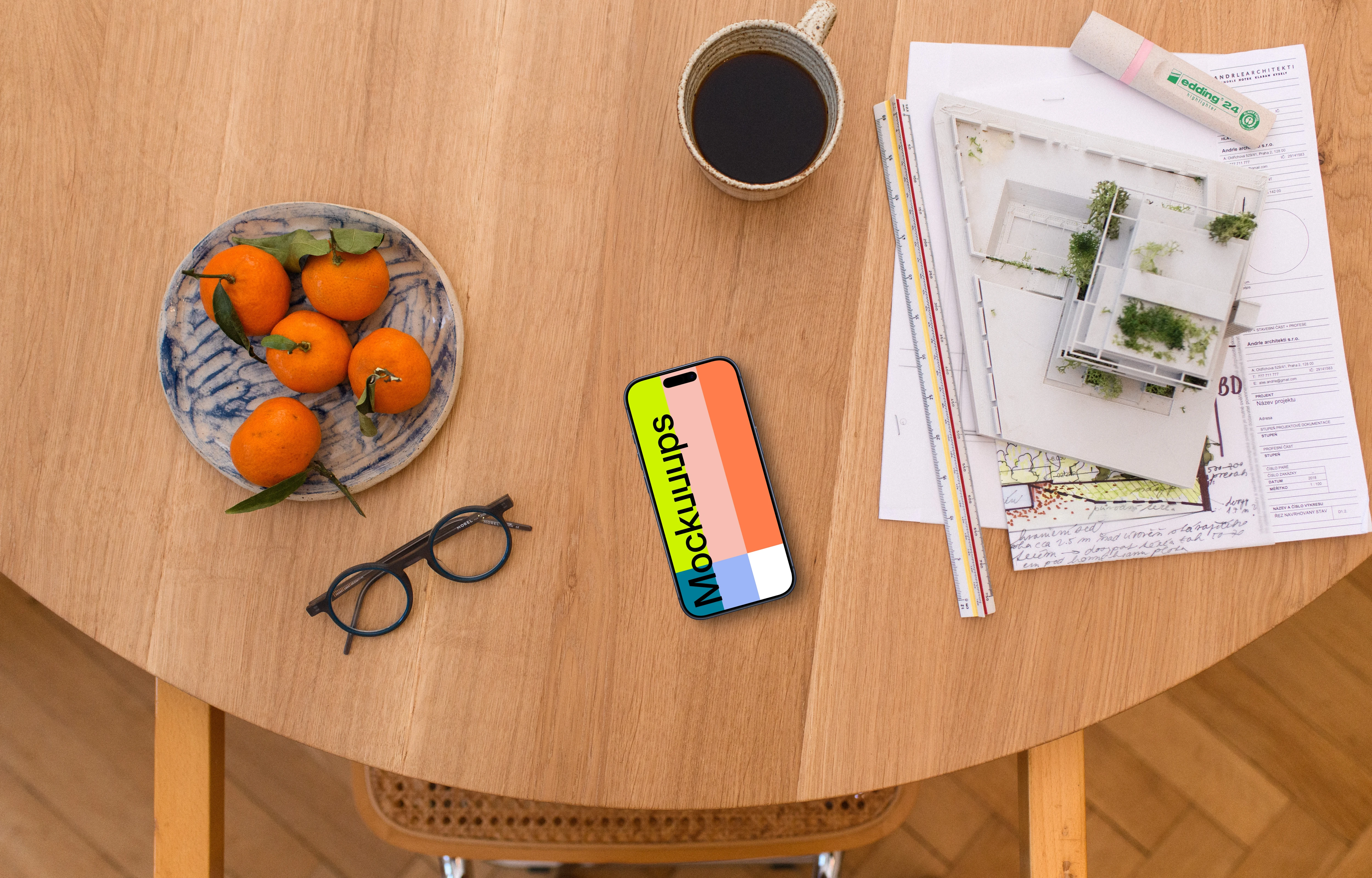 Smartphone mockup with architect's plans and coffee