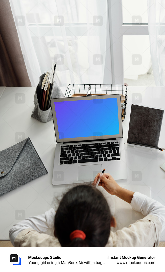 Young girl using a MacBook Air with a bag by the side mockup