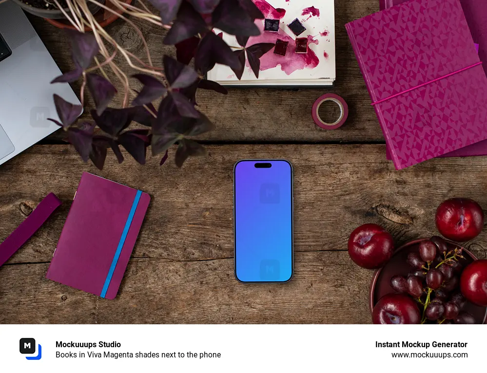 Books in Viva Magenta shades next to the phone