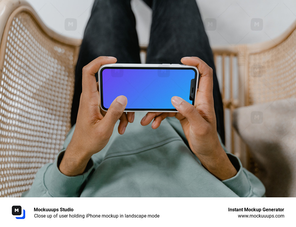 Close up of user holding iPhone mockup in landscape mode 