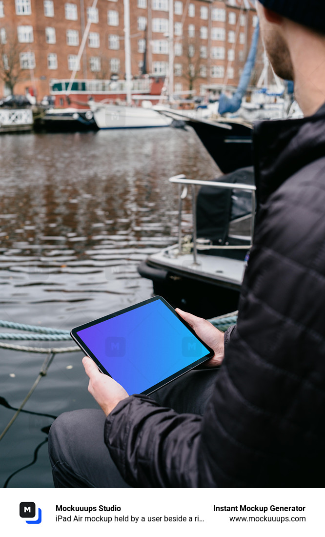 iPad Air mockup held by a user beside a river