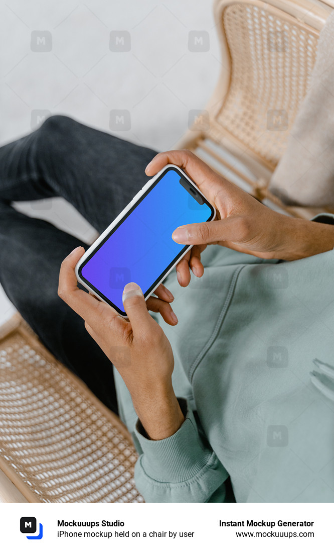 iPhone mockup held on a chair by user