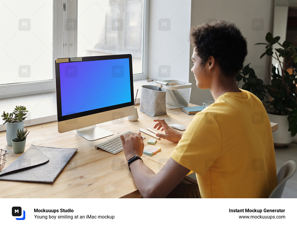 Young boy smiling at an iMac mockup