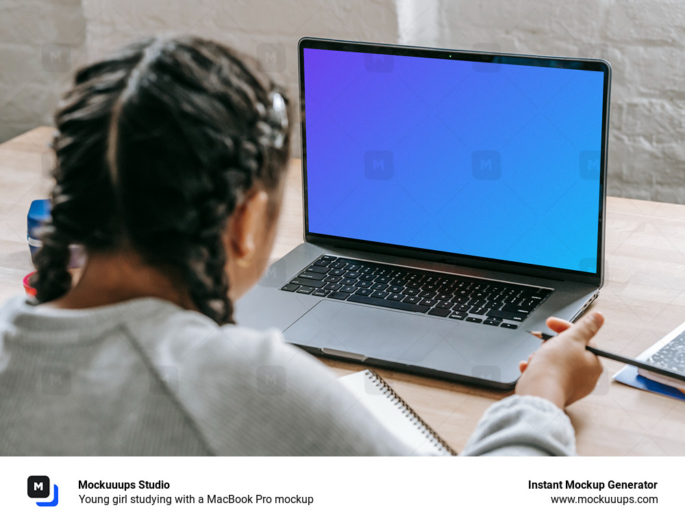 Young girl studying with a MacBook Pro mockup