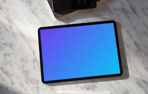 Tablet mockup on a table with an iPhone at the side