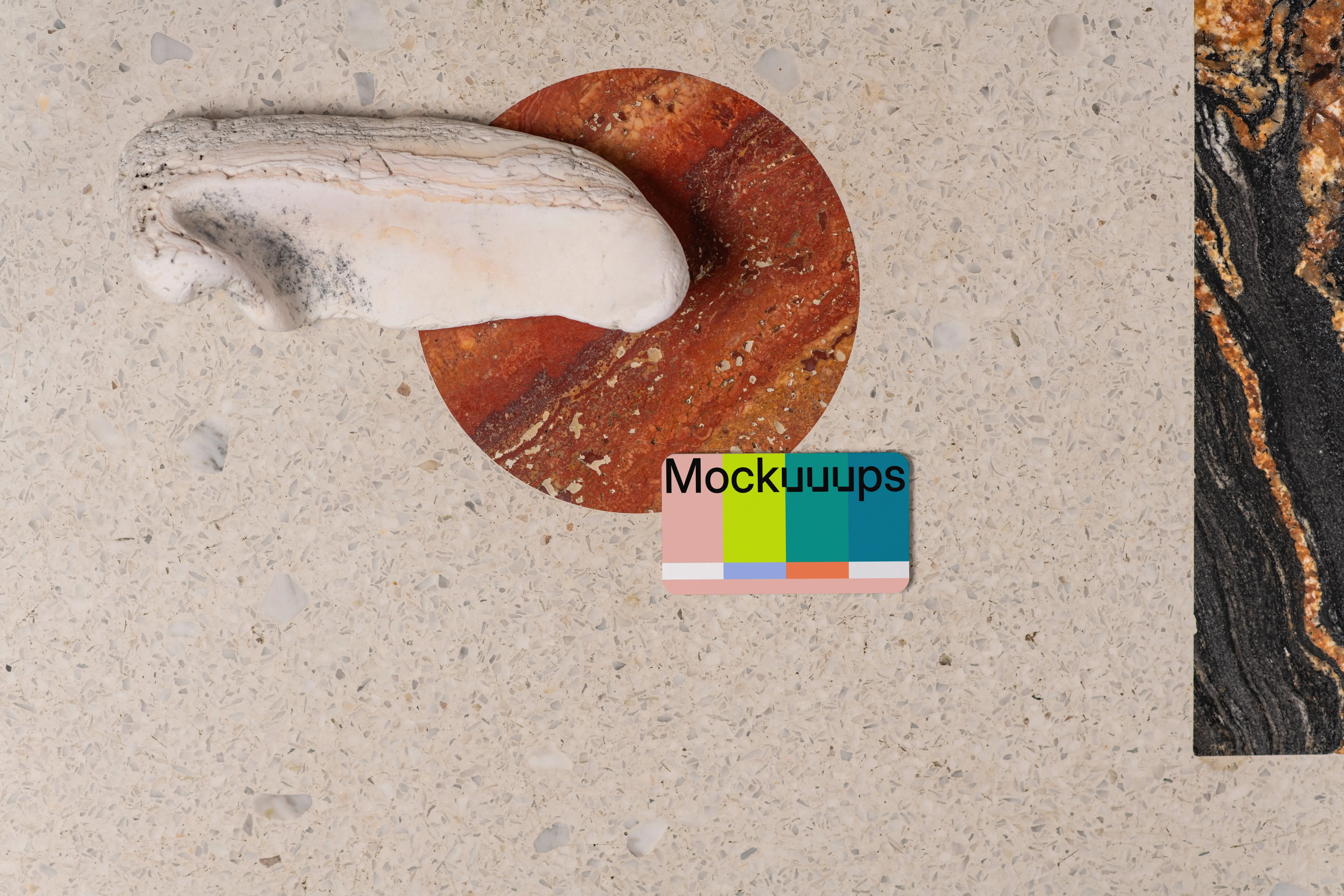 Business card mockup on a terrazzo surface with abstract accents