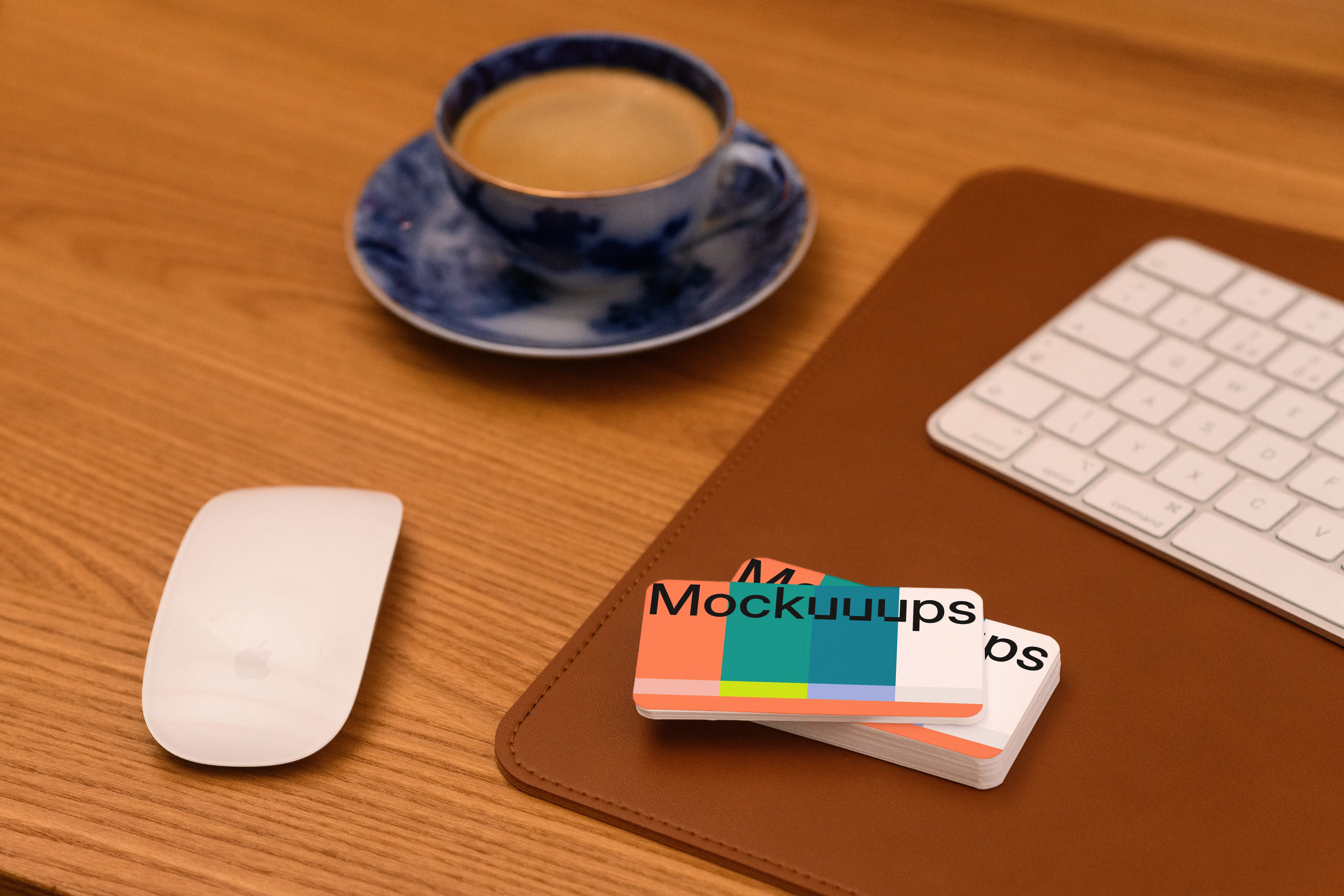 Business card mockup on a wooden desk with office items