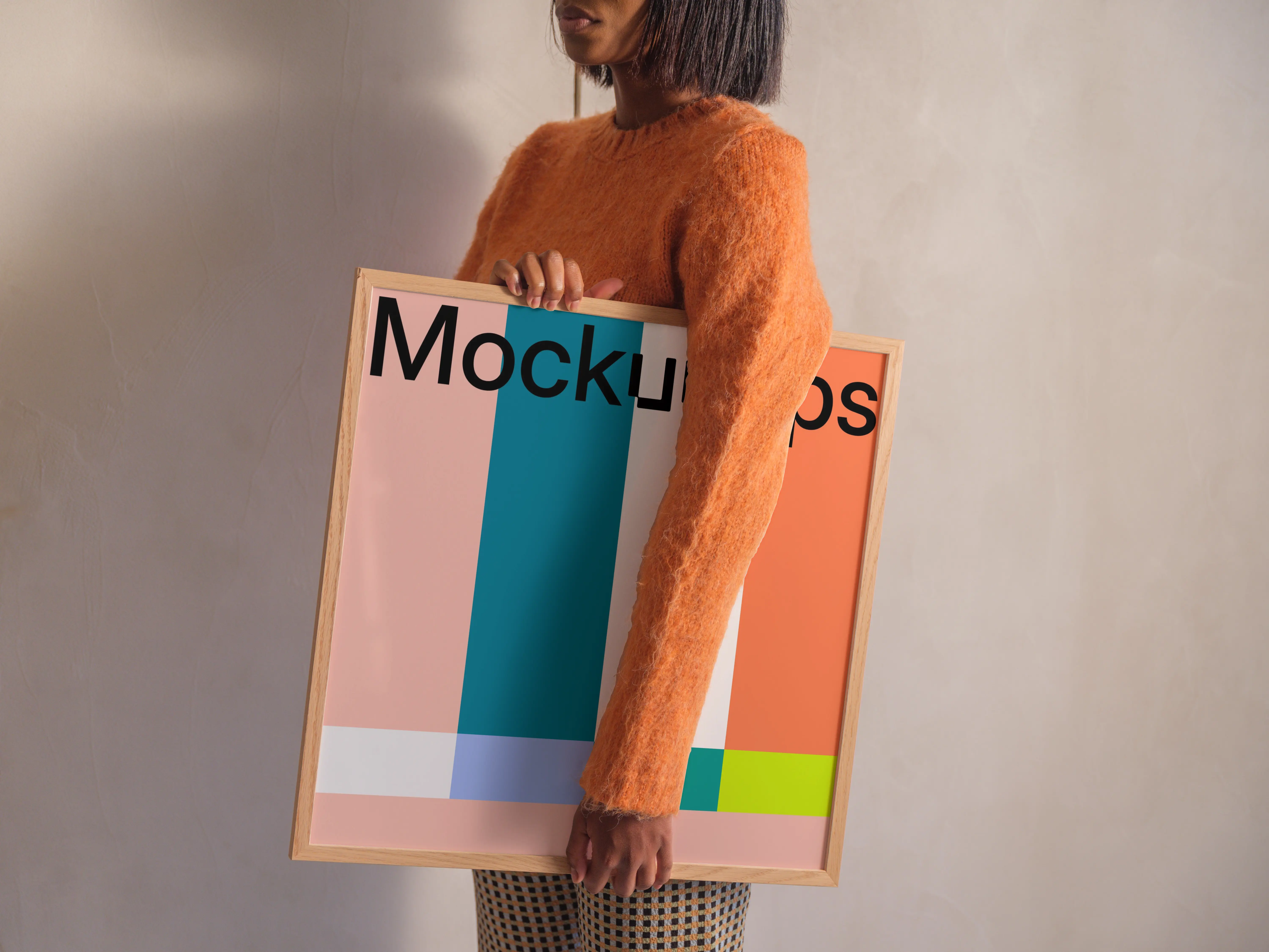 Framed mockup held by person in casual outfit