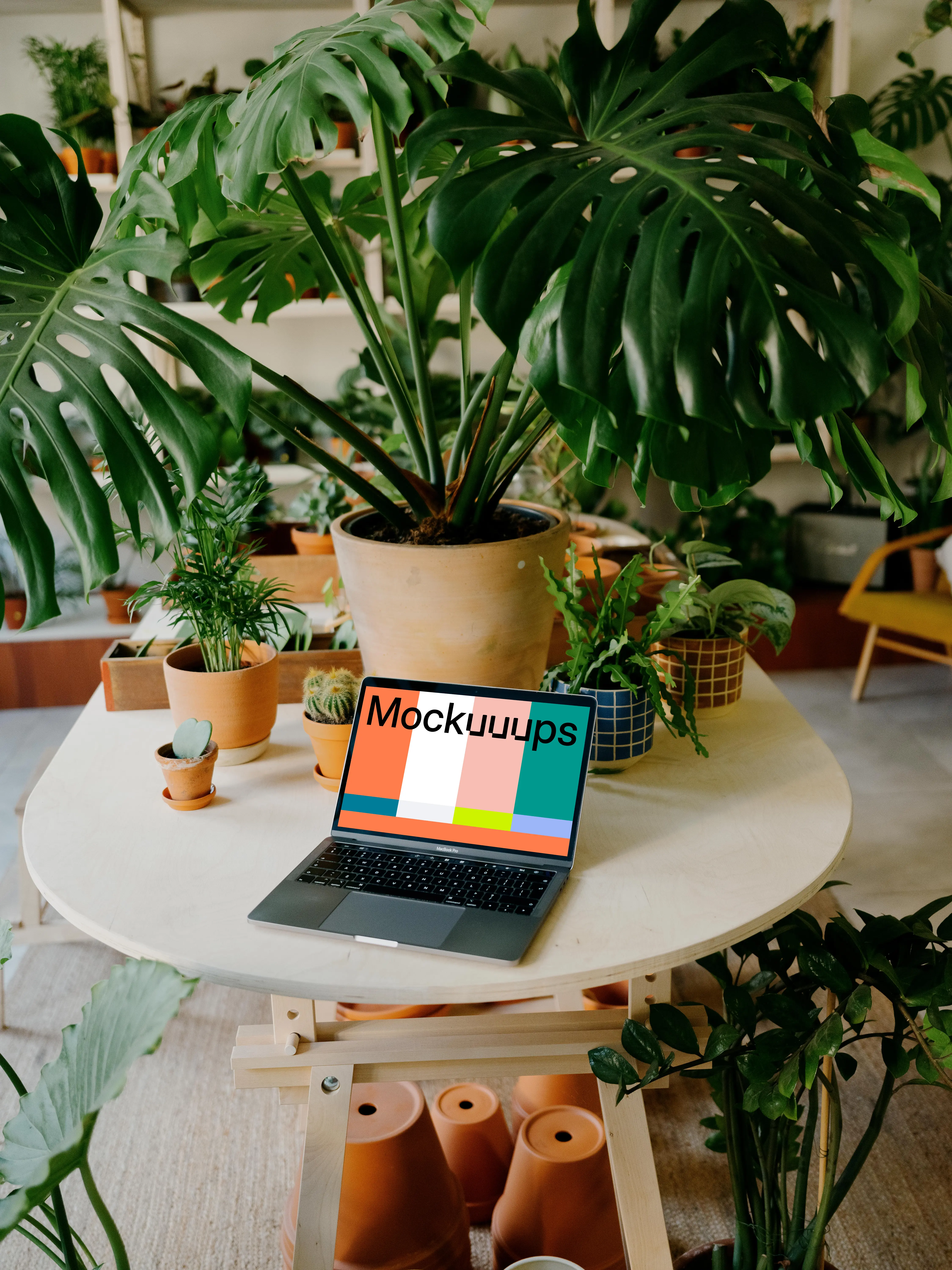Grey MacBook Pro mockup on a round table