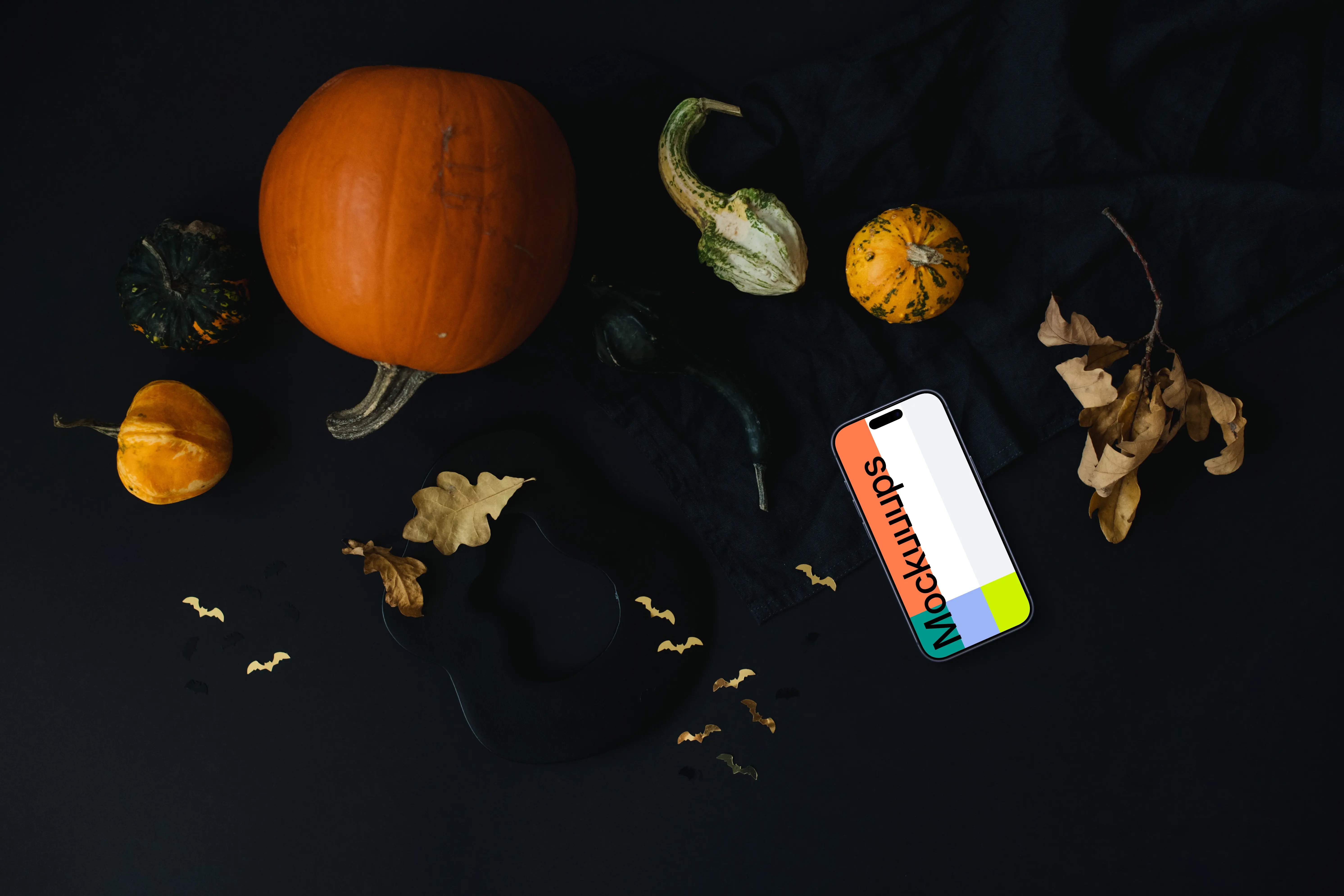 Halloween pumpkin mockup with a smartphone on the dark background