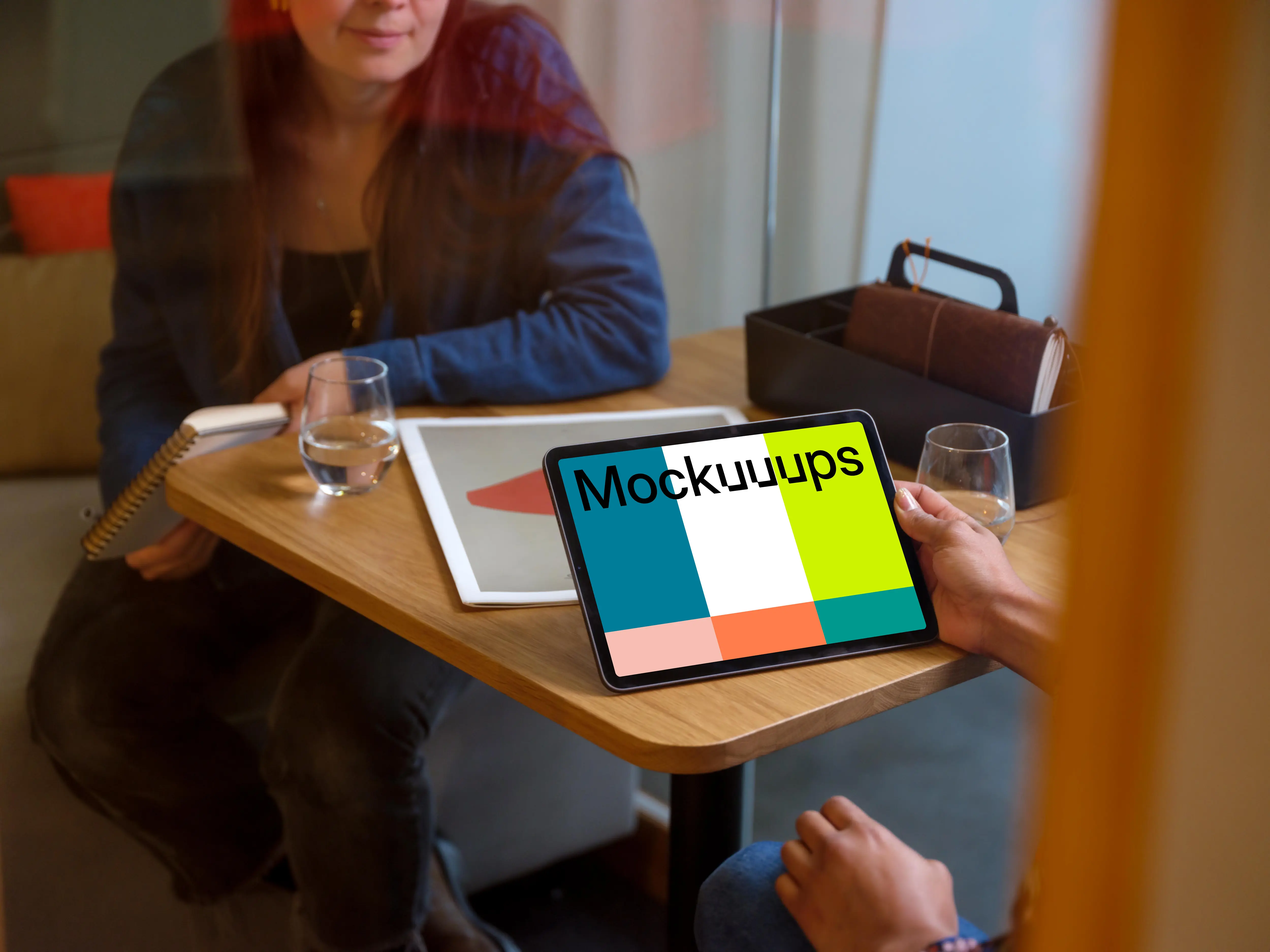 Hand holding an iPad Air mockup in office