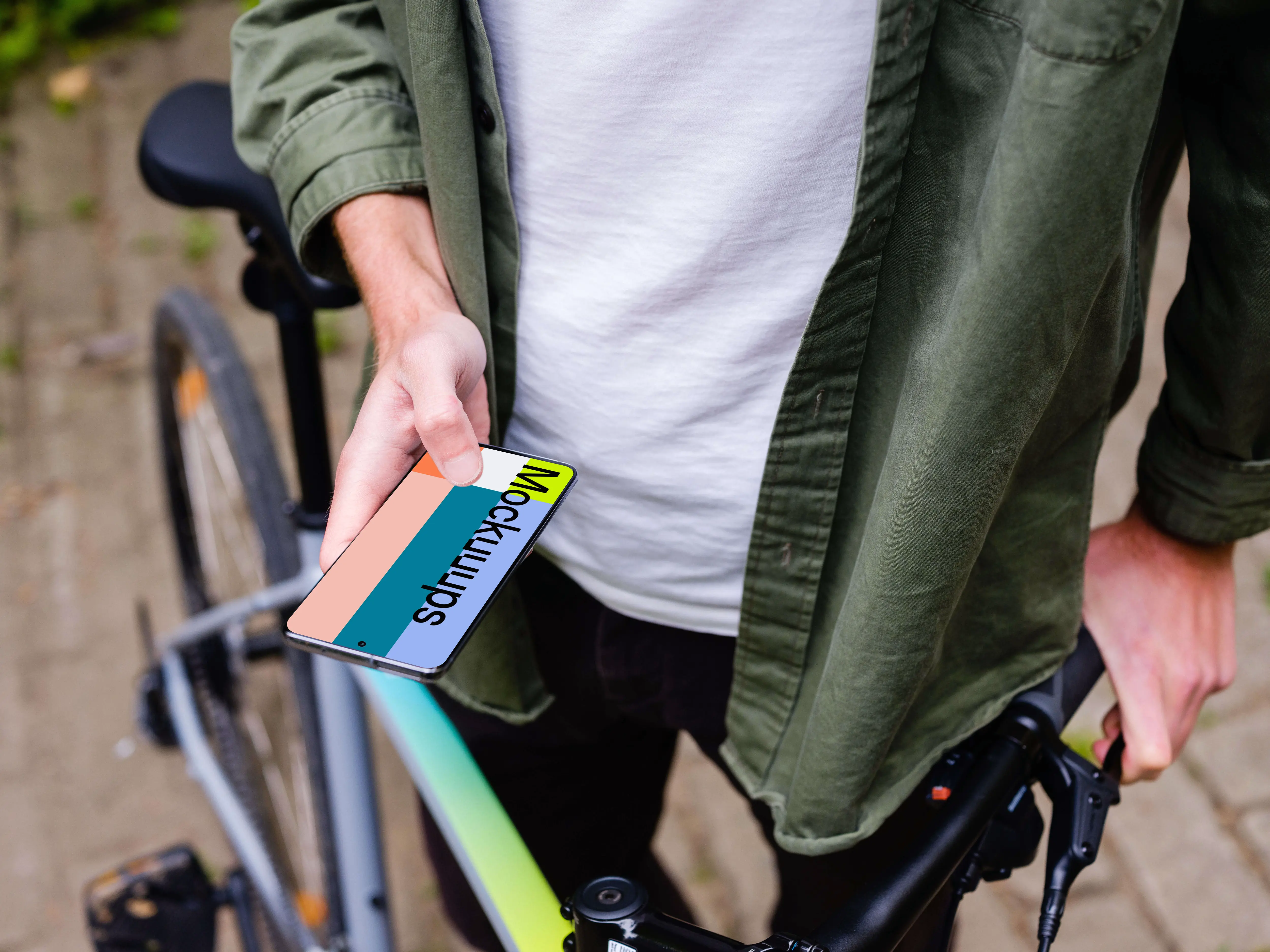 Free Holding Samsung S20 mockup in front of a bike