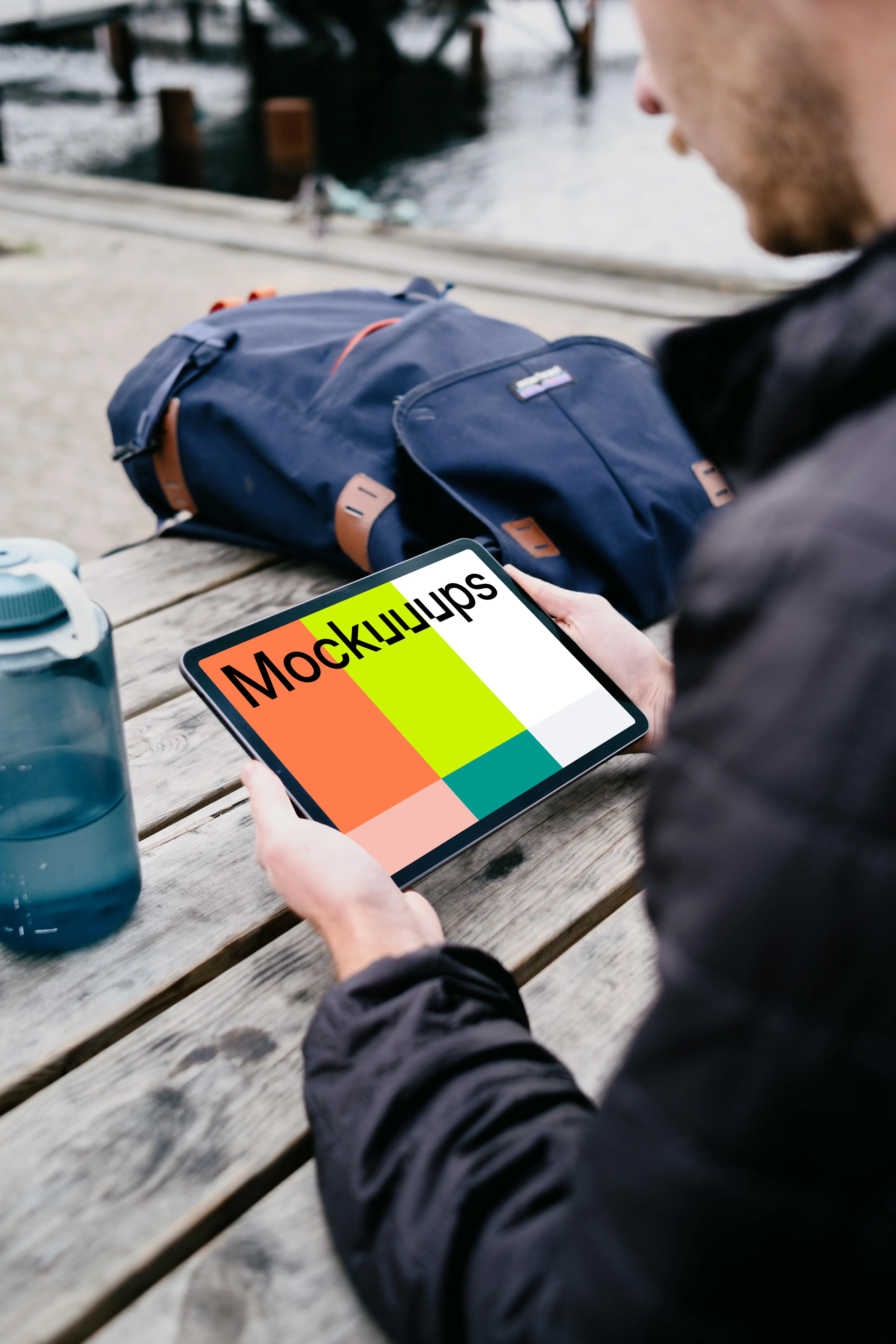 iPad Air mockup in a user’s hand with a backpack in the background