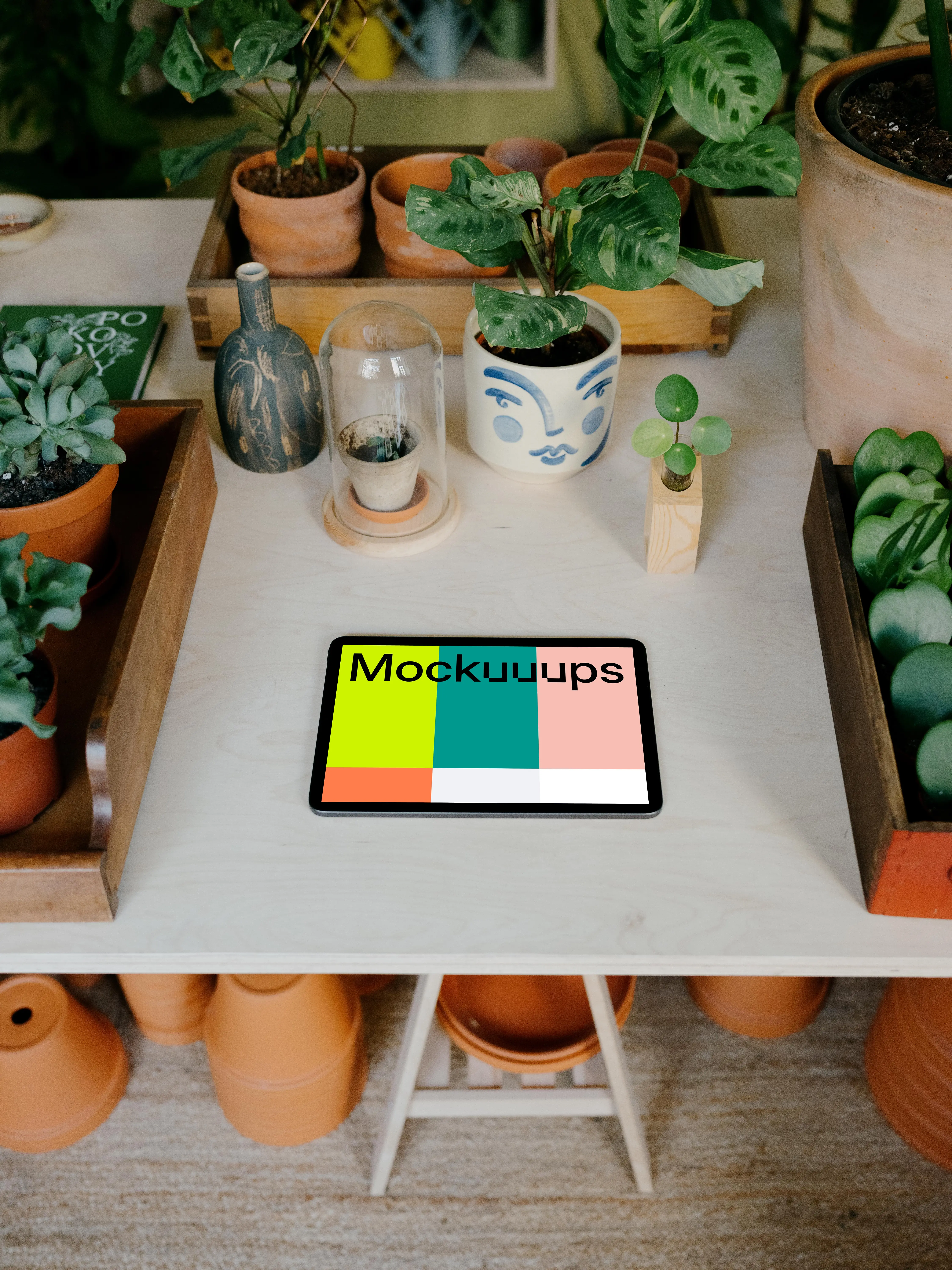 iPad Air mockup on a table with potted plants
