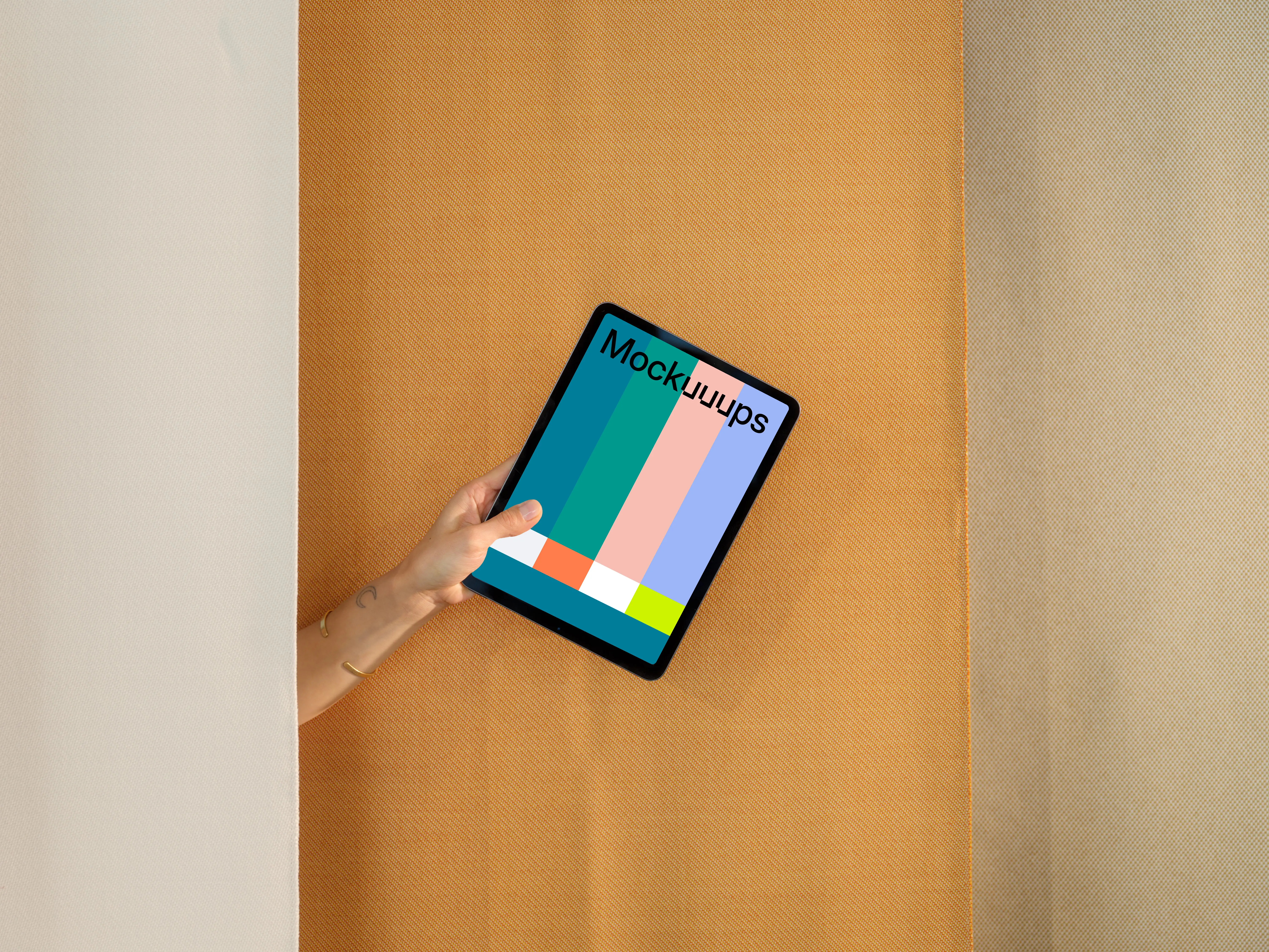 iPad Air mockup with a person holding it against a dual-tone backdrop