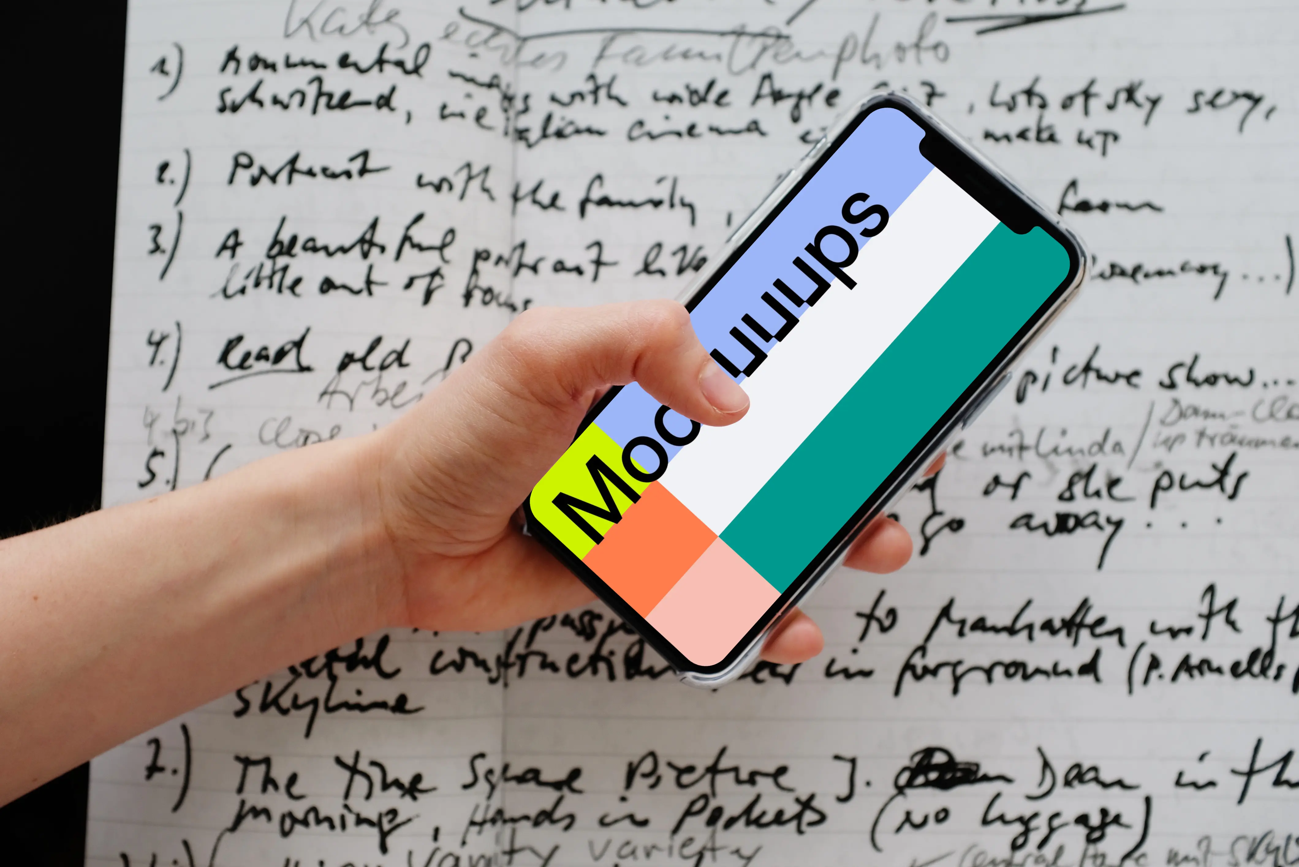 iPhone 12 Pro mockup held over a sheet of paper