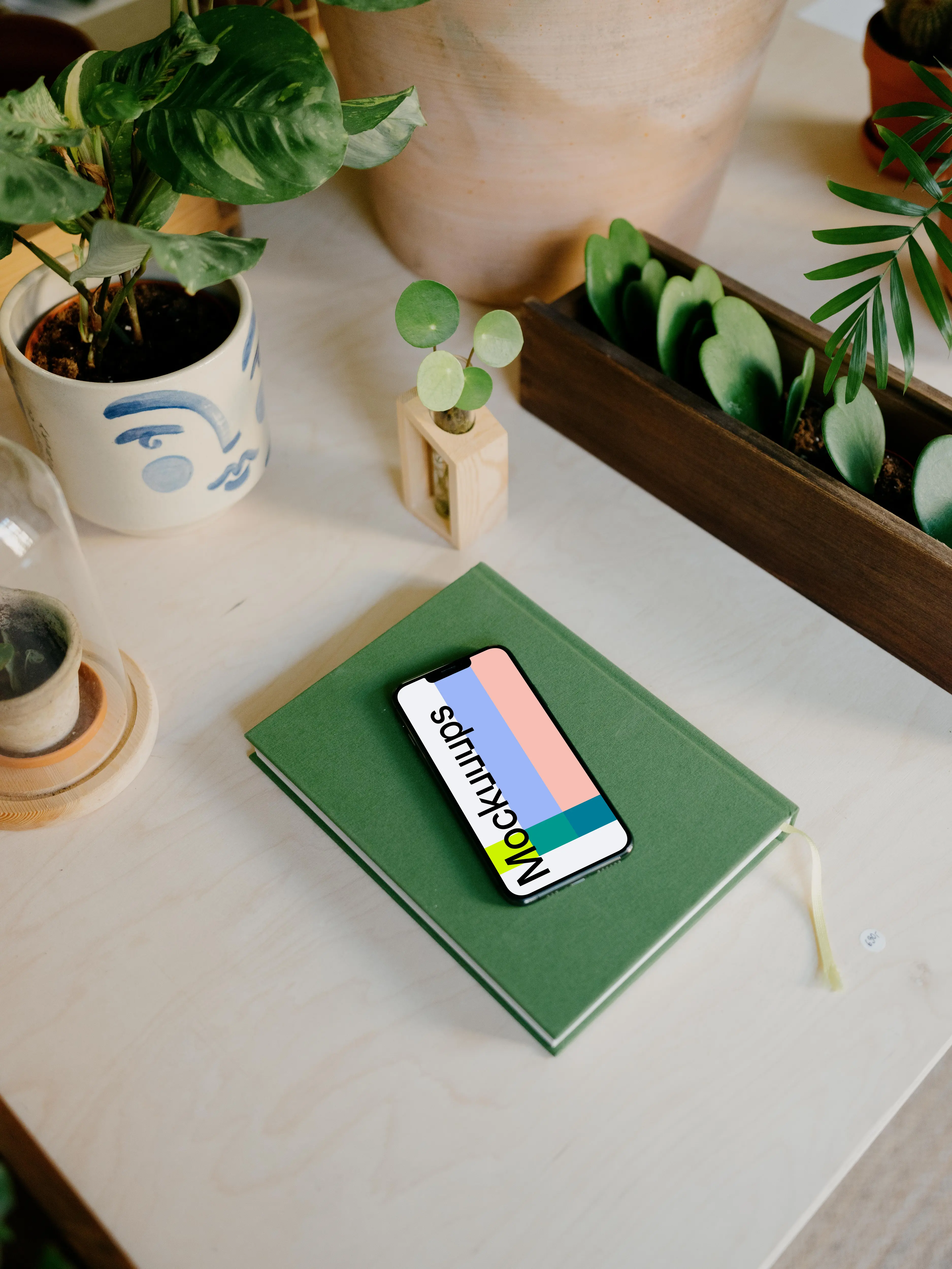 iPhone 13 Pro on a green notepad