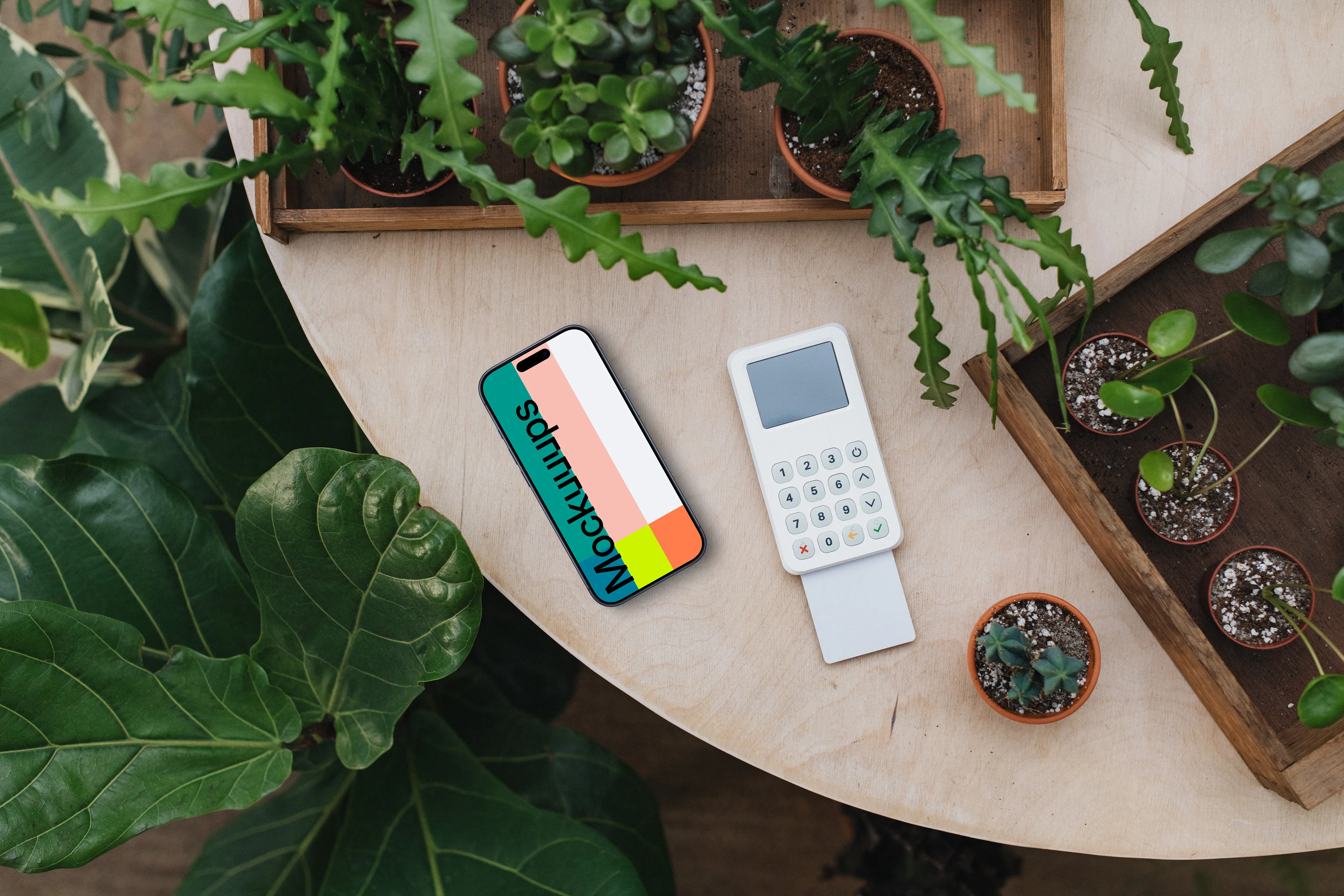 iPhone mockup amongst lush greenery with card terminal