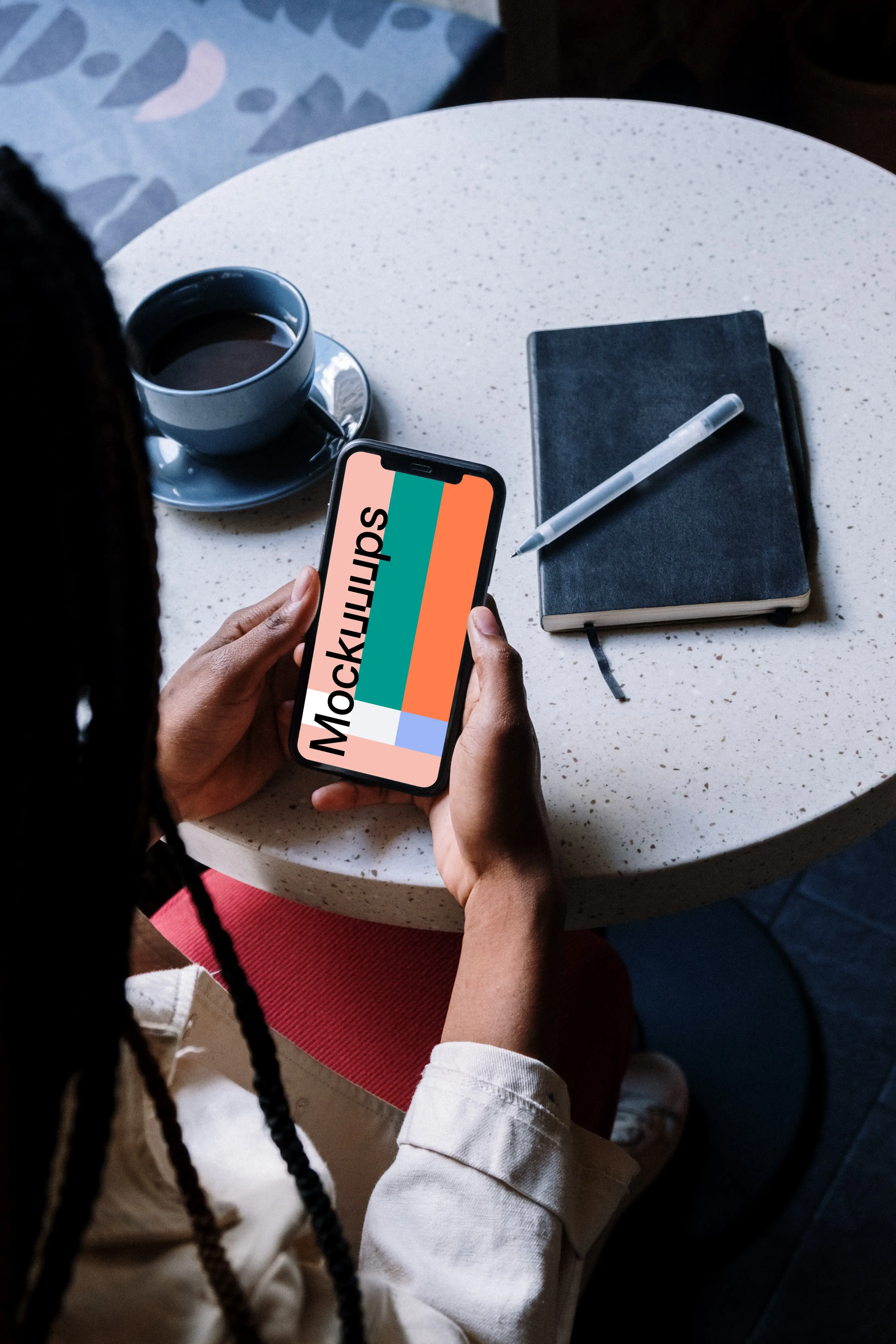 iPhone mockup in a ladies hand with a cup of coffee by the side