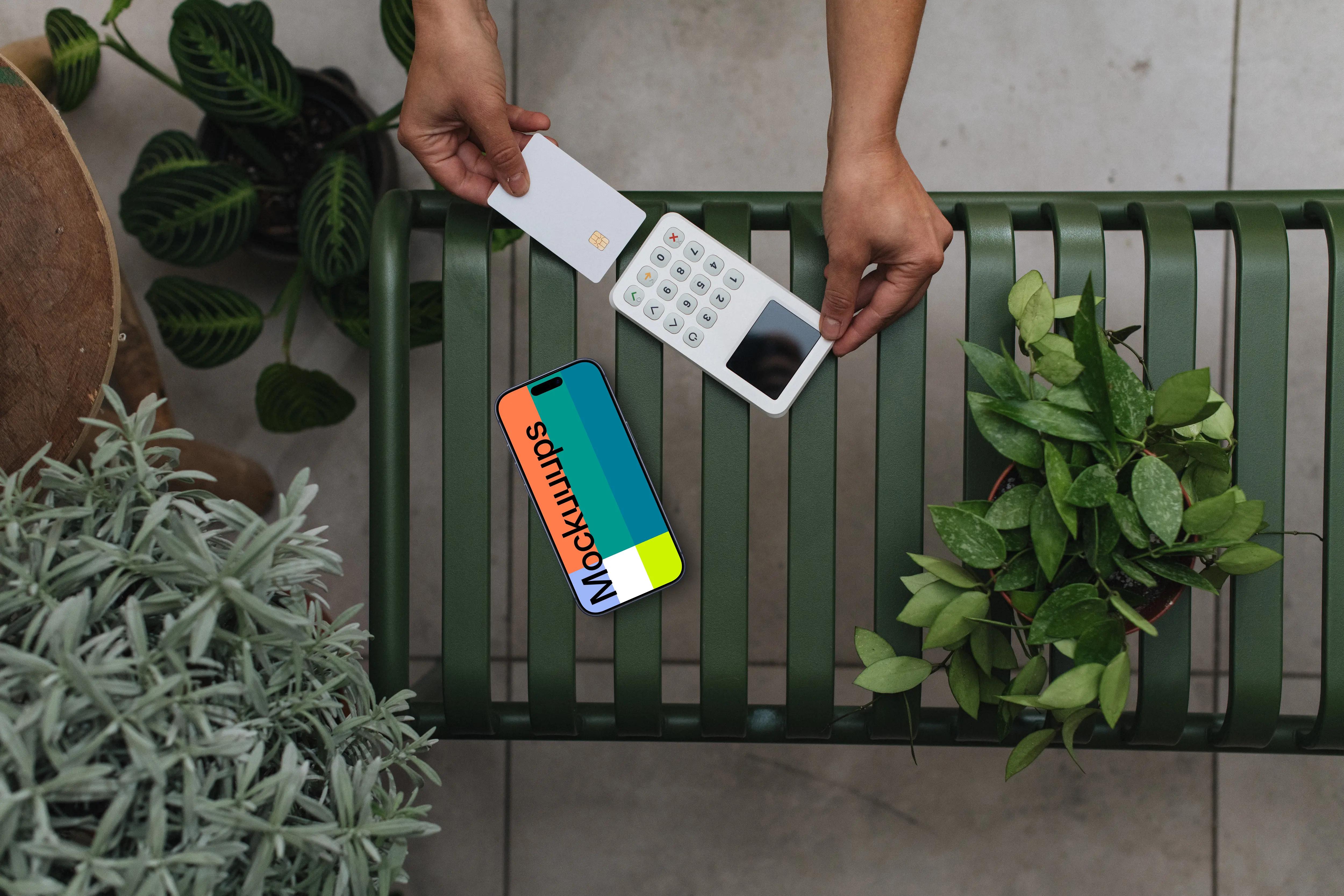 iPhone mockup with credit card terminal amidst plants