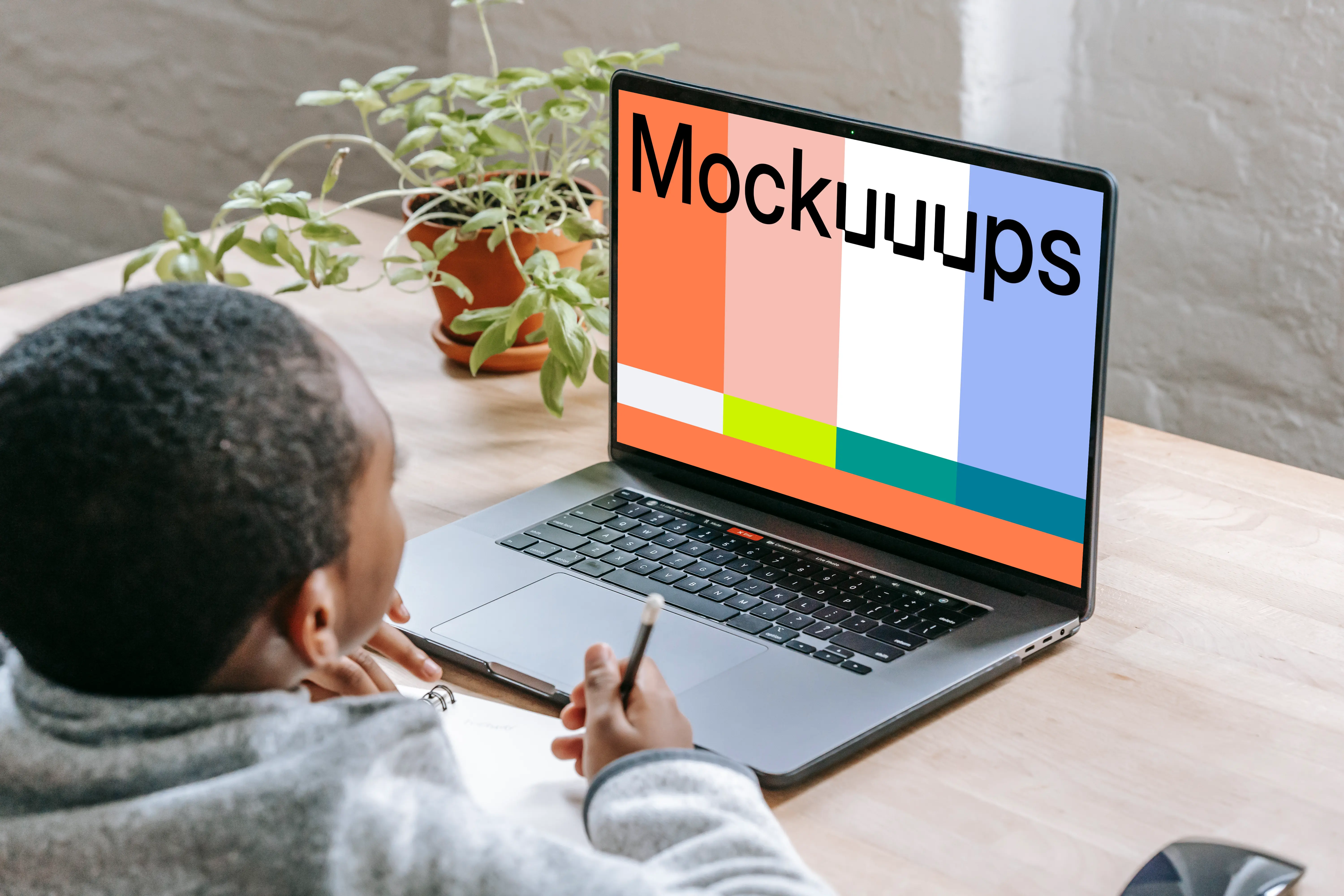 Kid studying with a gray MacBook Pro mockup