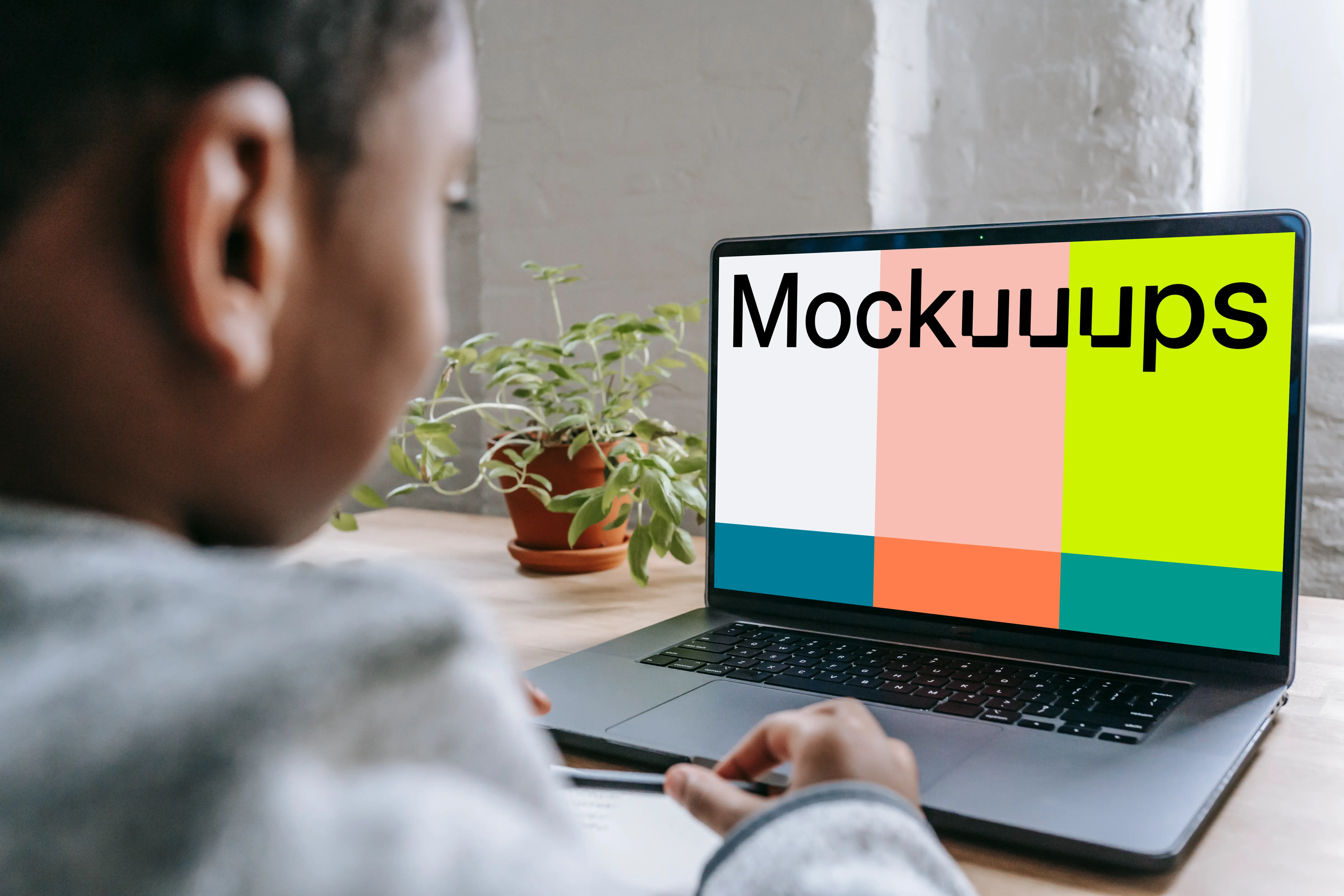 Little boy using a gray MacBook Pro mockup