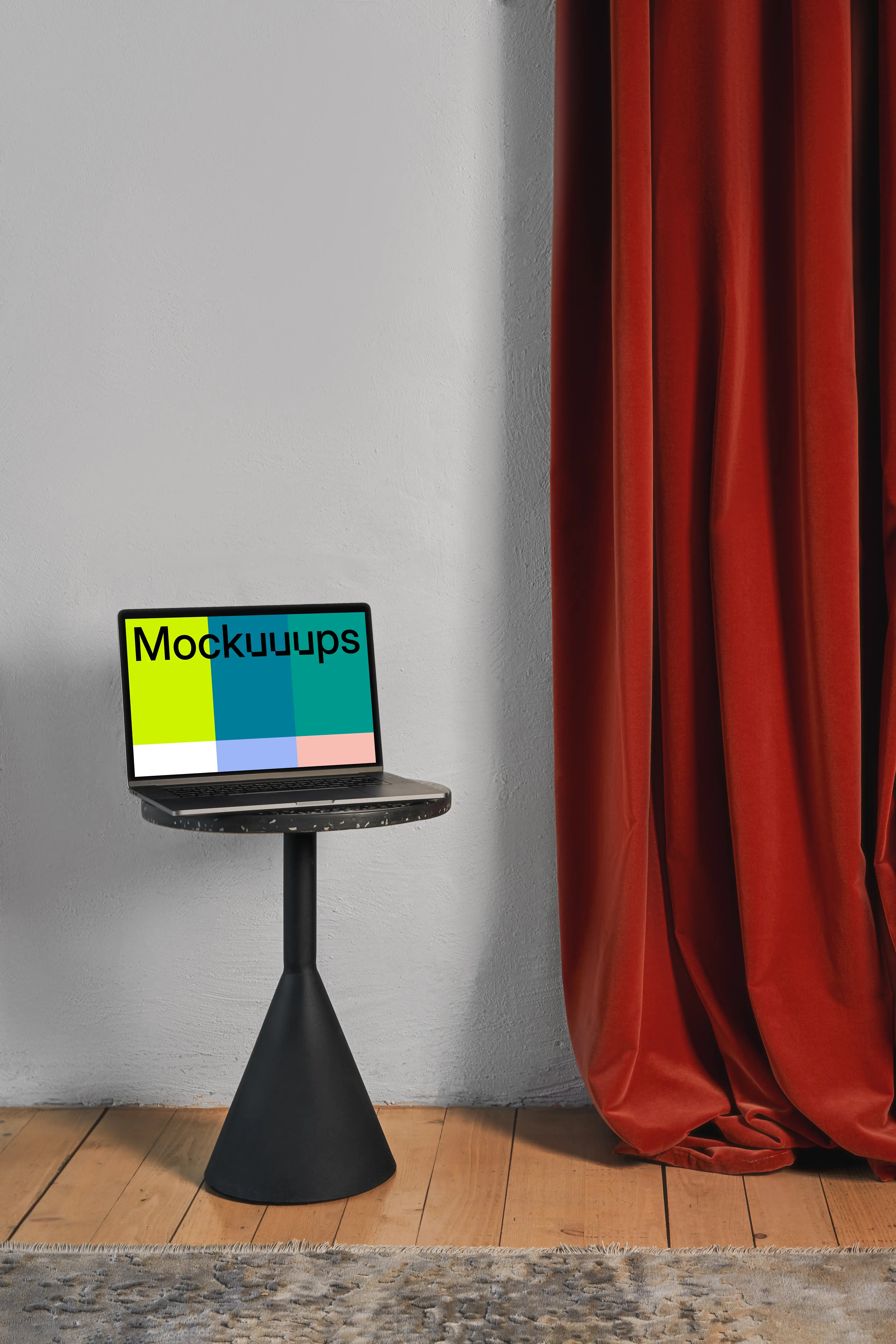 MacBook mockup on a black stool with red curtain in the background