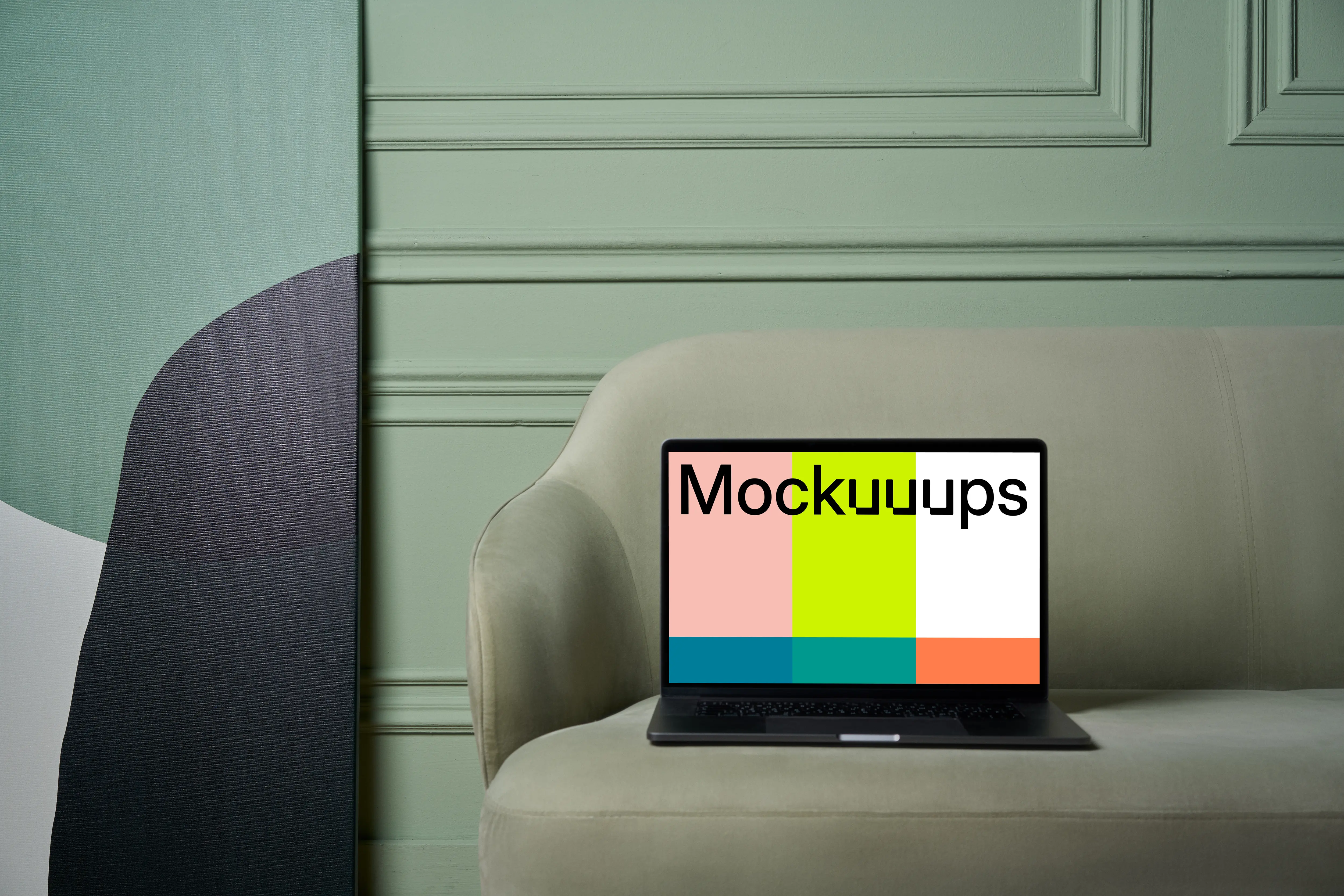 MacBook mockup on a couch with beside painting
