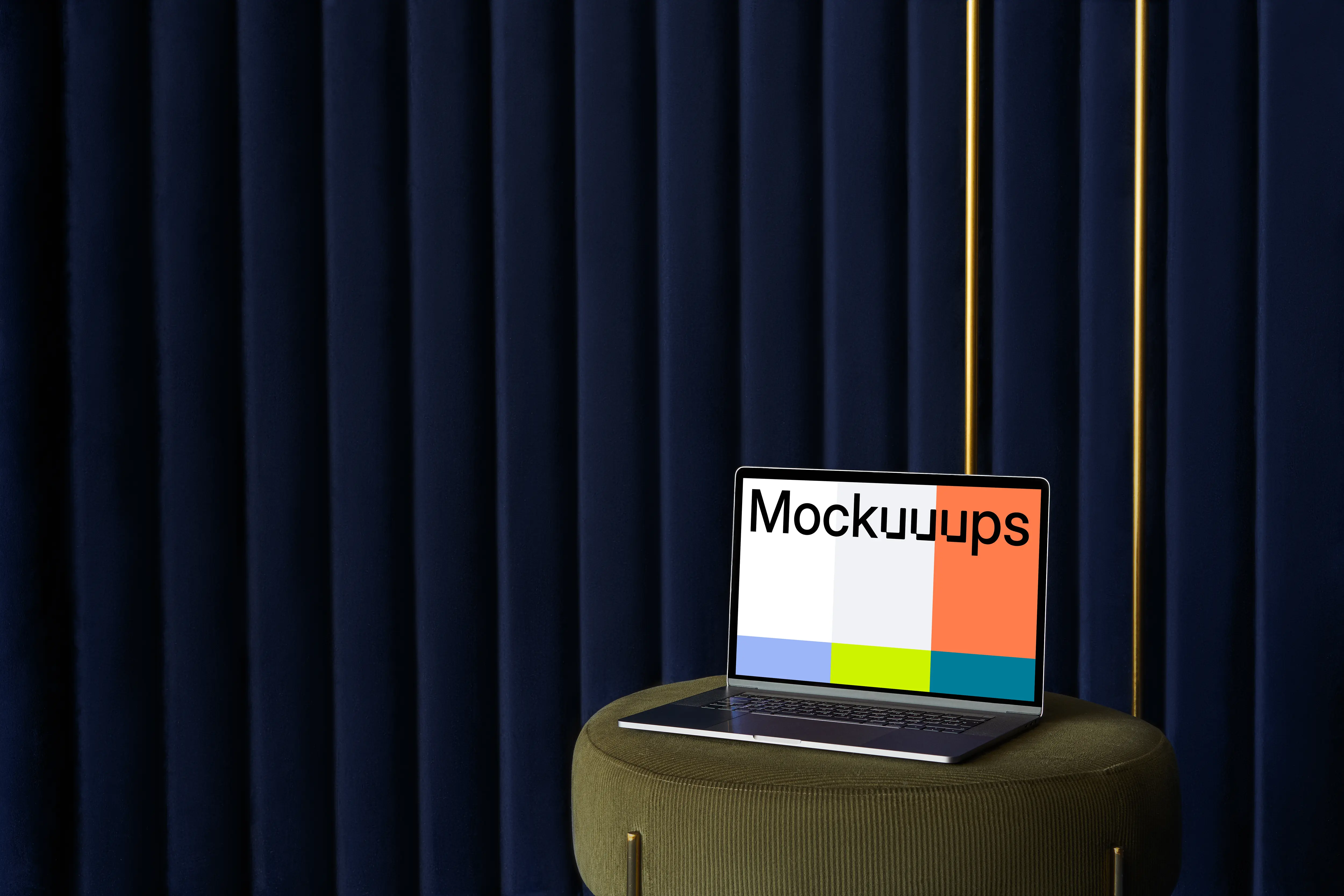 MacBook mockup on a sofa stool with a blue curtain in the background