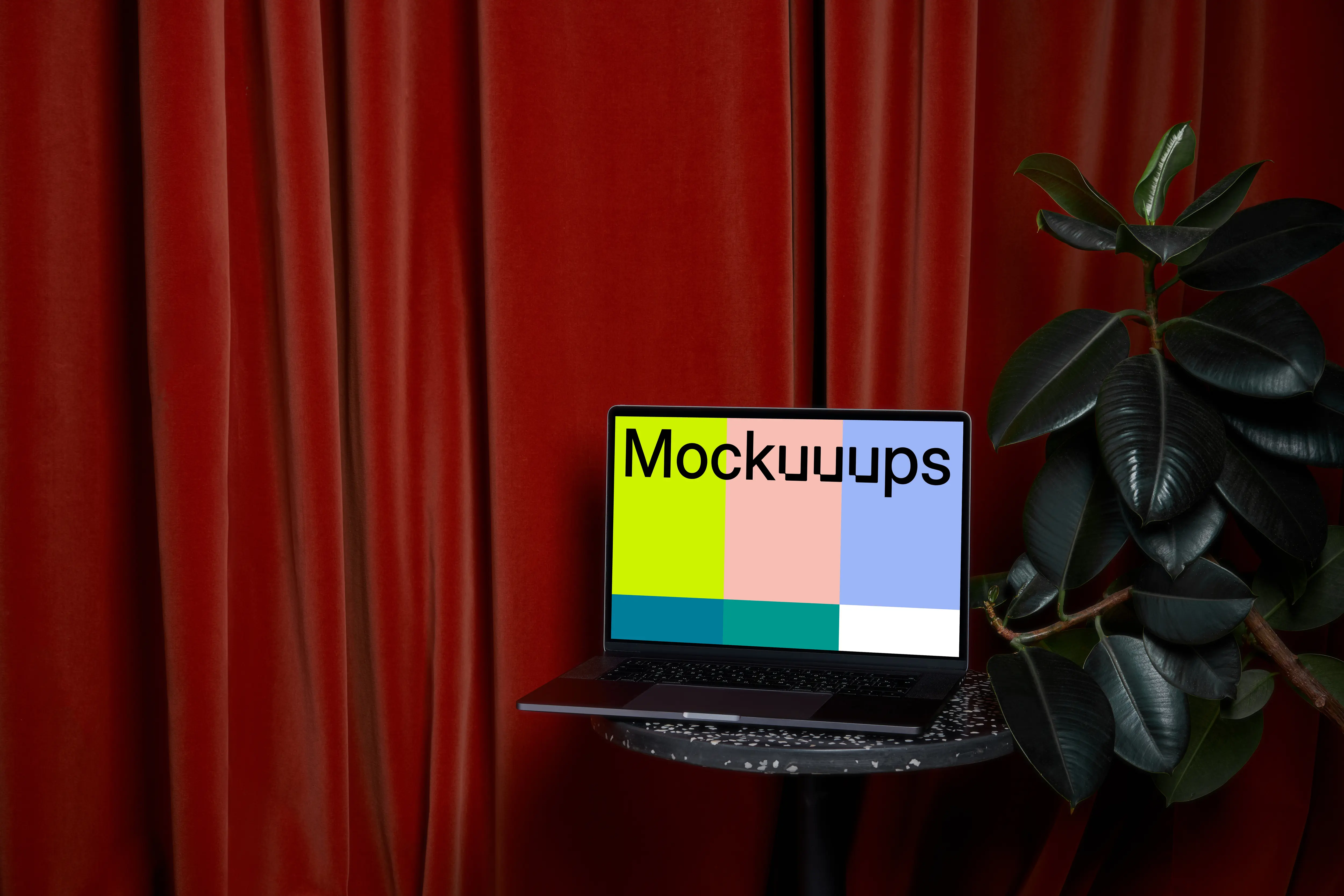 MacBook mockup on a stool beside flower pot