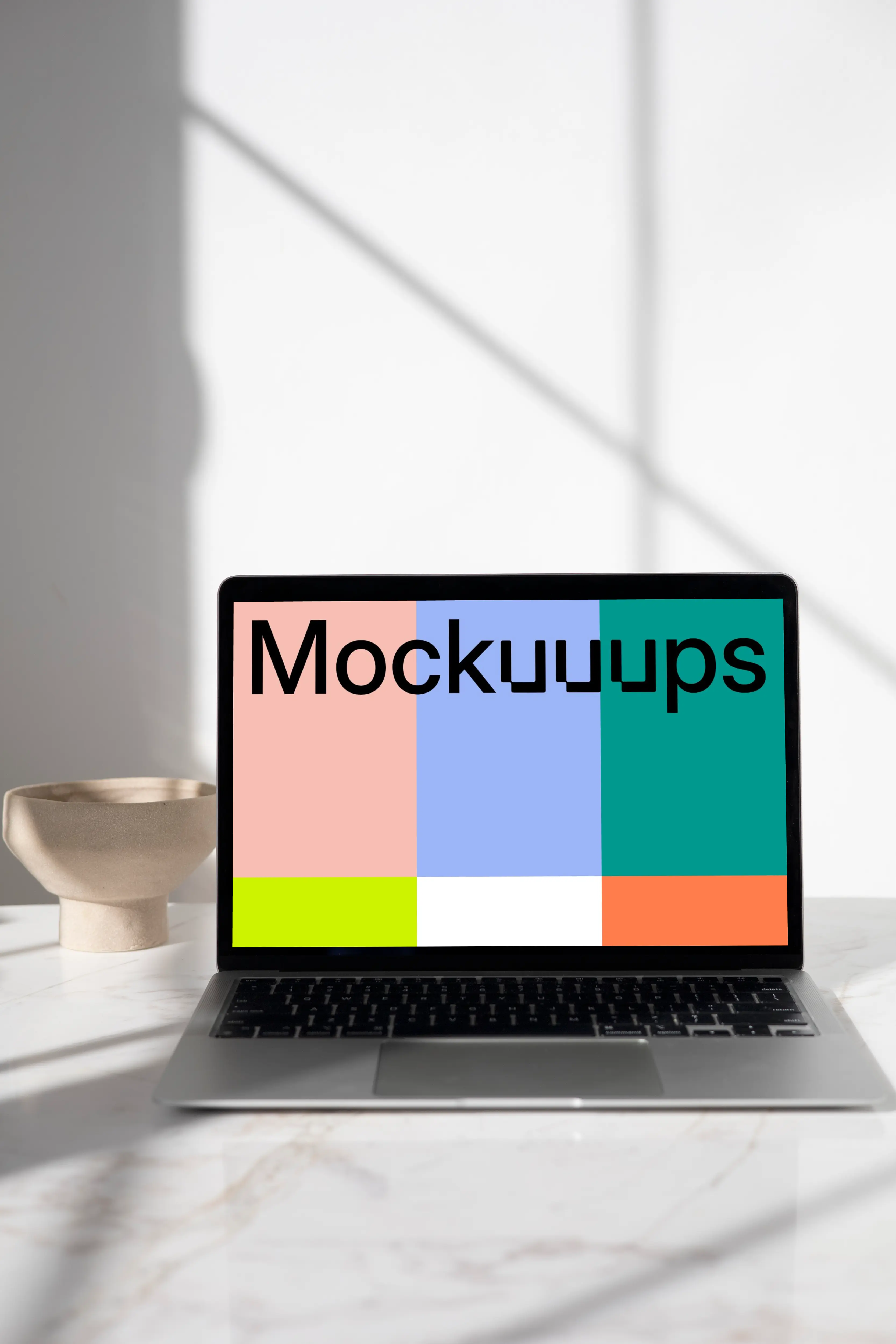 MacBook mockup on a table with ceramic bowl in the background