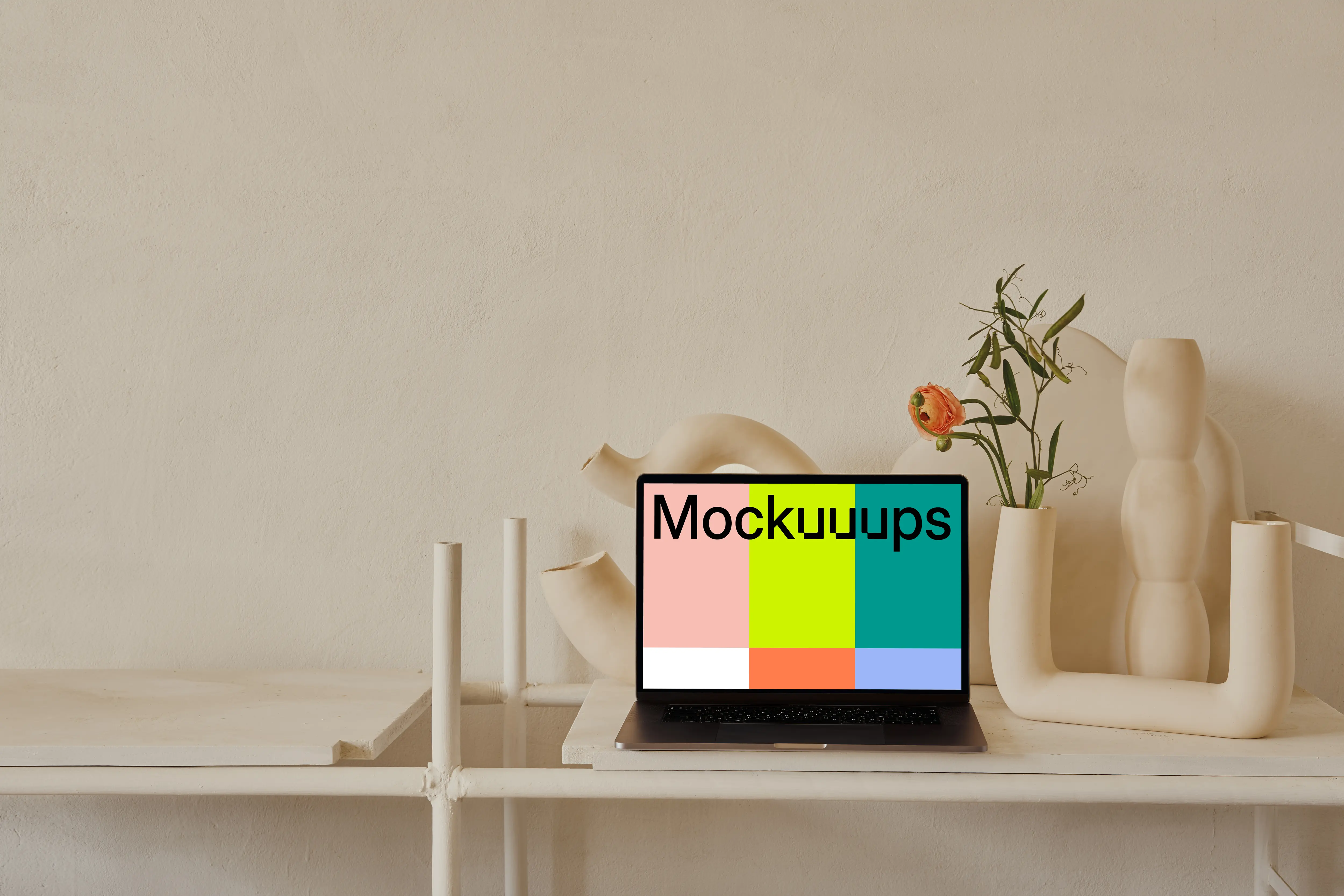MacBook mockup on a table with peach coloured flower vase at the side