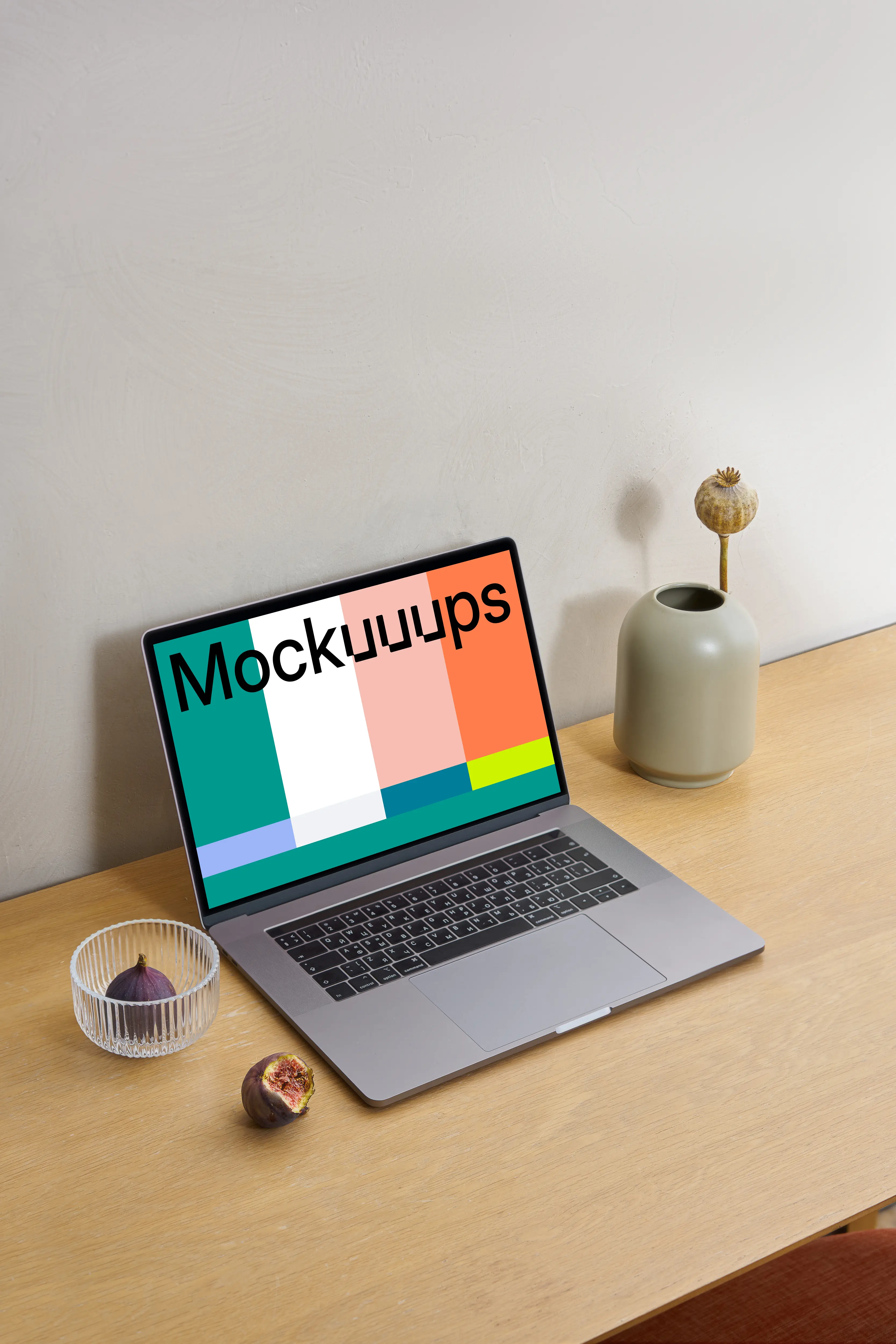 MacBook mockup on a wooden workstation table