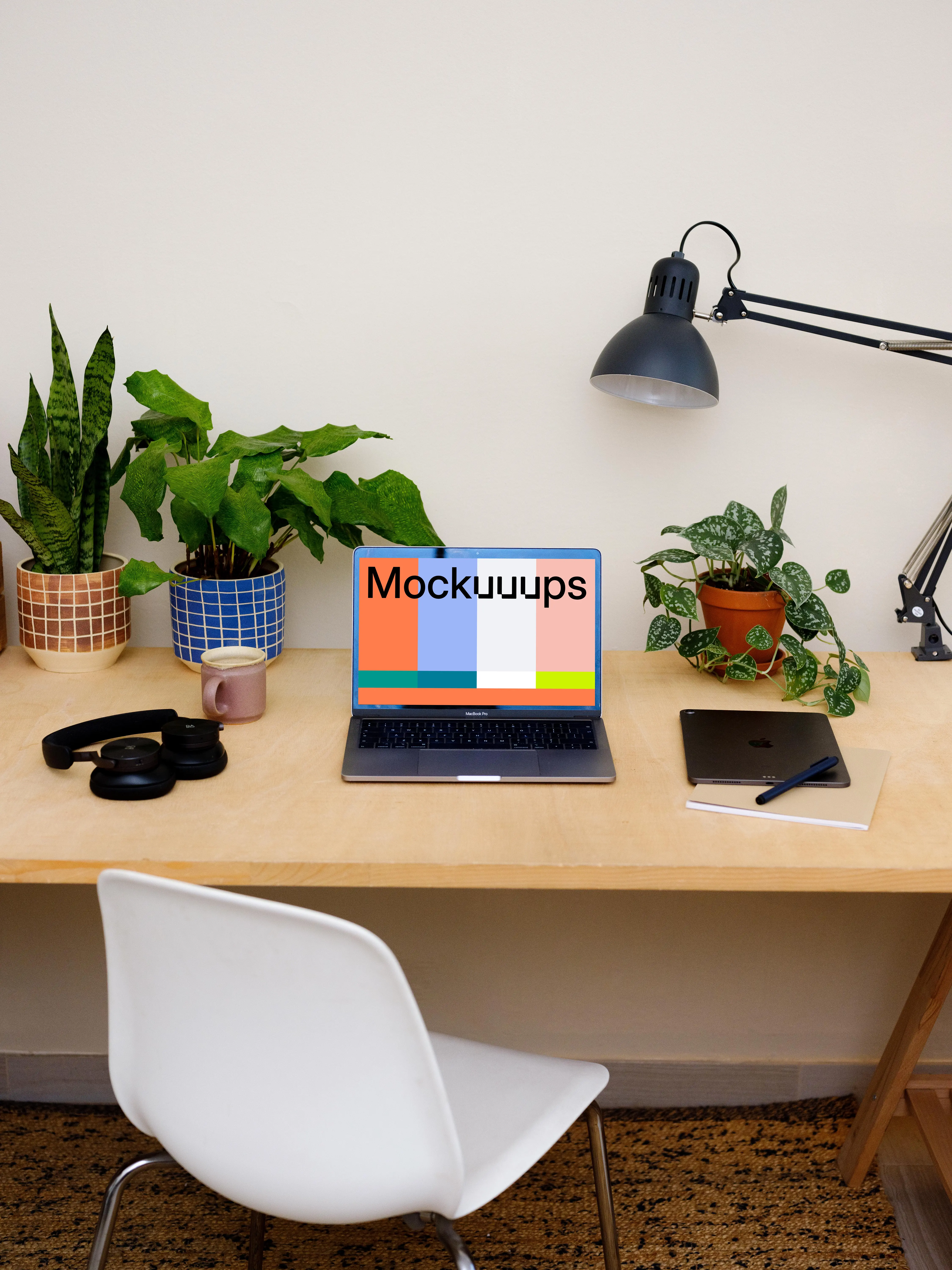 MacBook Pro mockup on a table with an iPad at the side.