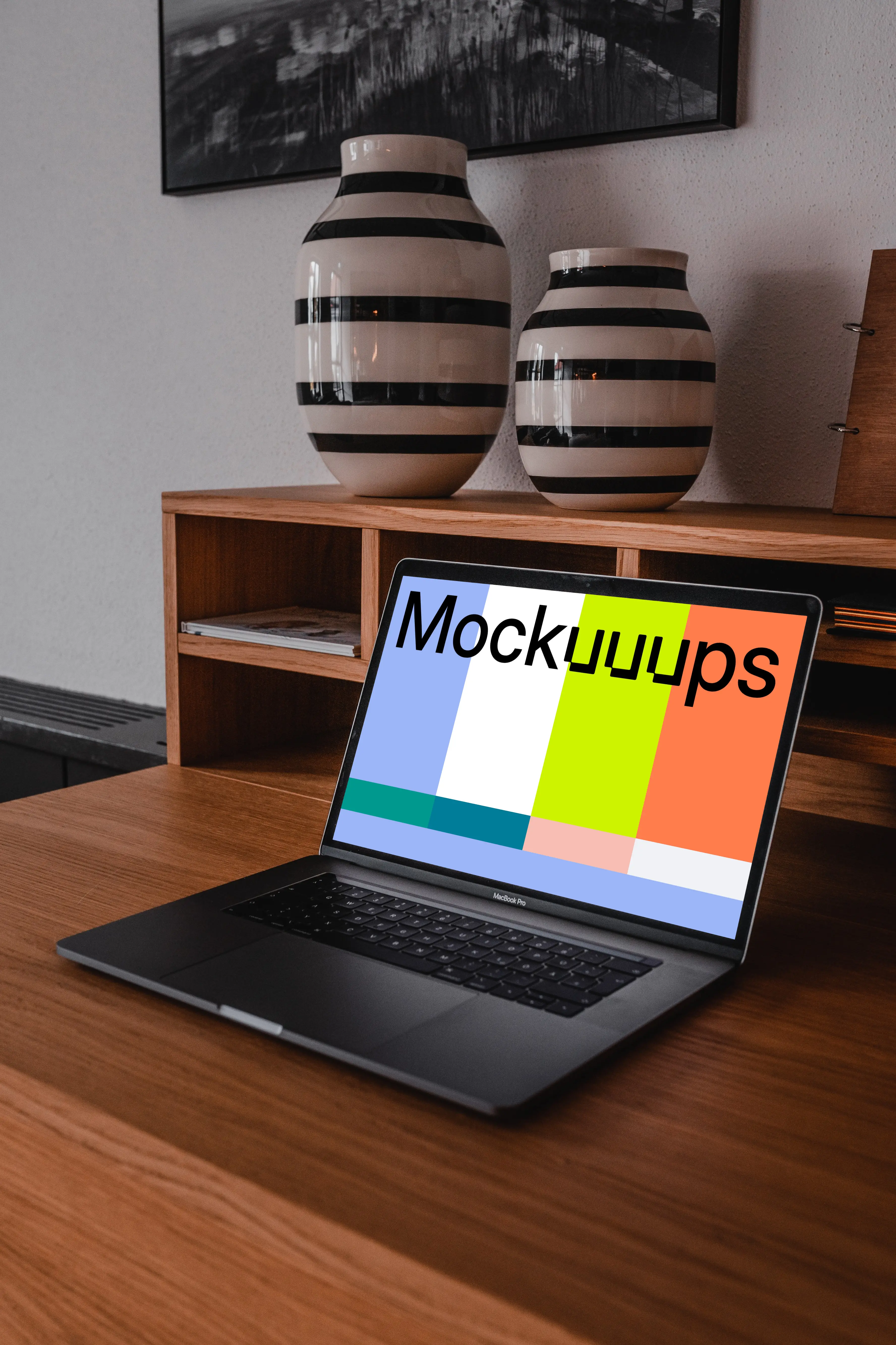 MacBook Pro mockup on a table with pottery above it